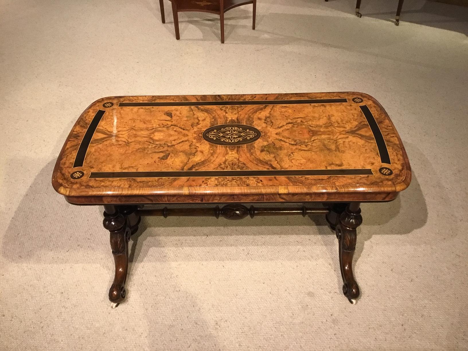 A Victorian Period burr walnut & ebony inlaid antique coffee table. Having a rectangular top with rounded corners veneered in beautifully figured burr walnut with an ebony inlaid border and central marquetry panel. Supported on four turned and