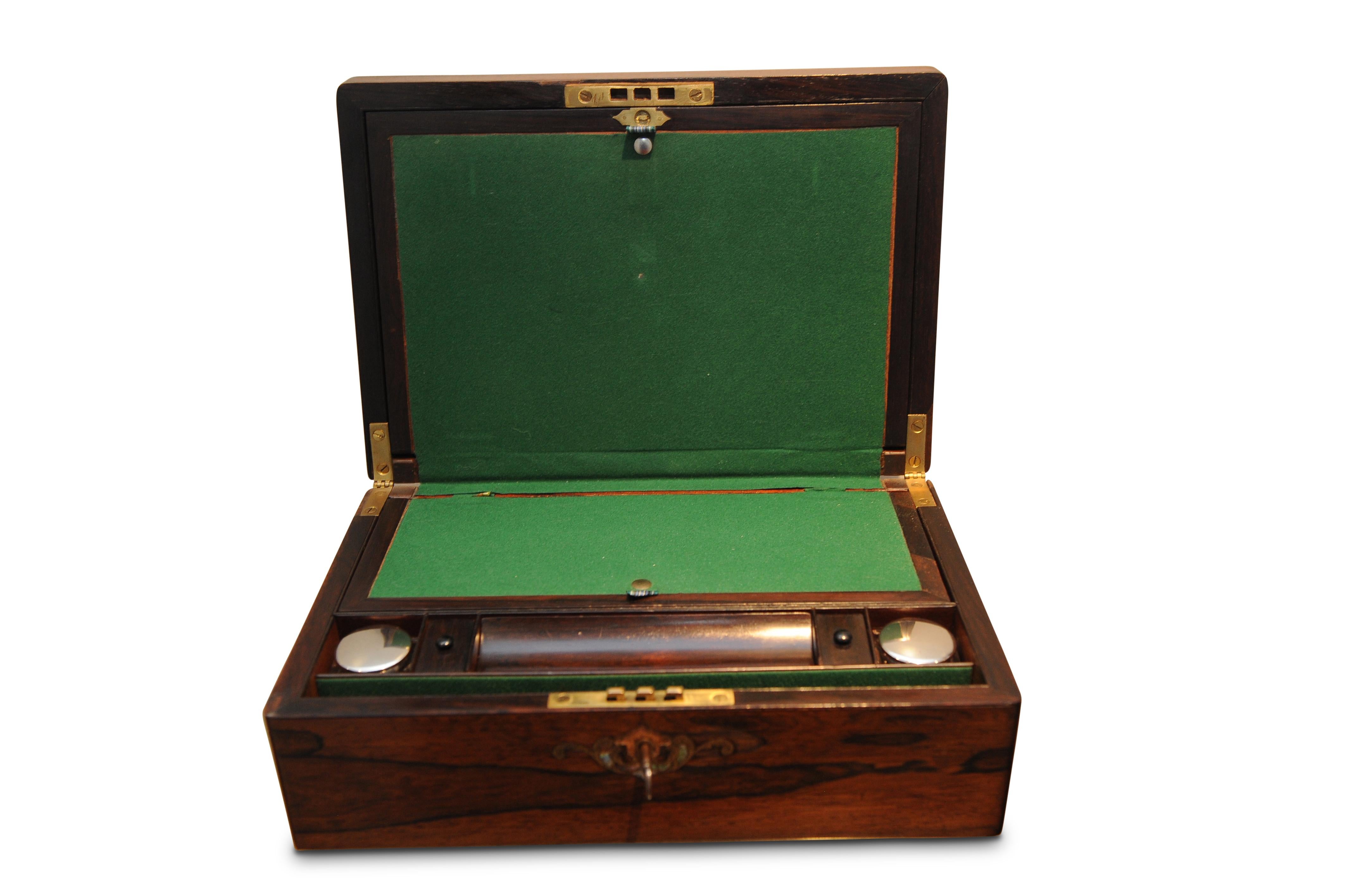 An elegant mid-19th century early Victorian rosewood writing slope desk tidy box having an inset mother of pearl fixture to the lid. Hinged lid opening to reveal a fully appointed green baize slope, twin silver lidded inkwells, added vintage