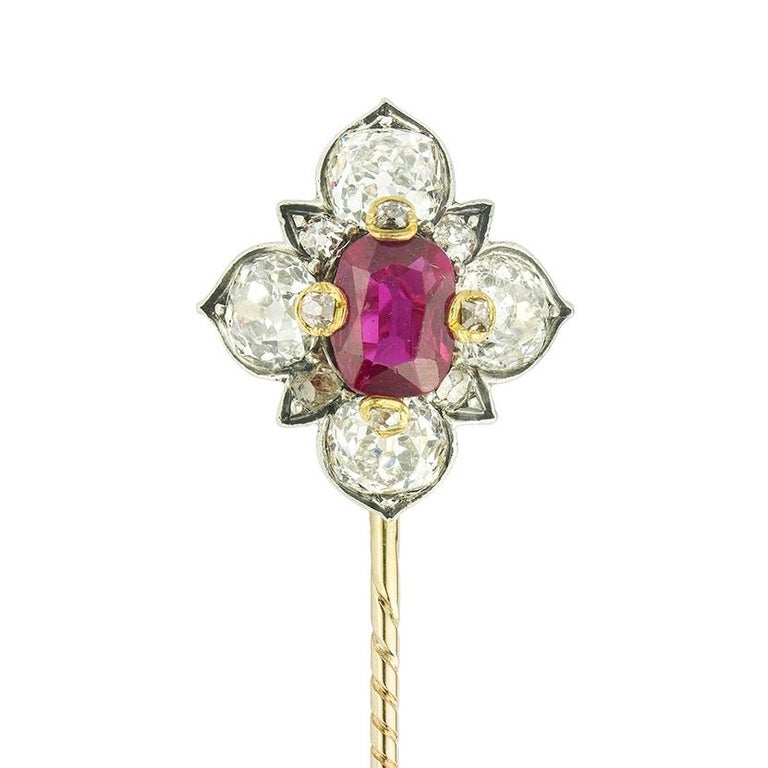 A Victorian ruby and diamond cluster stick pin, the cushion-cut ruby estimated to weigh 0.7 carats, four claw set in yellow gold with rose-cut diamond tips, surrounded by four old brilliant-cut diamond set petals with smaller rose-cut diamonds