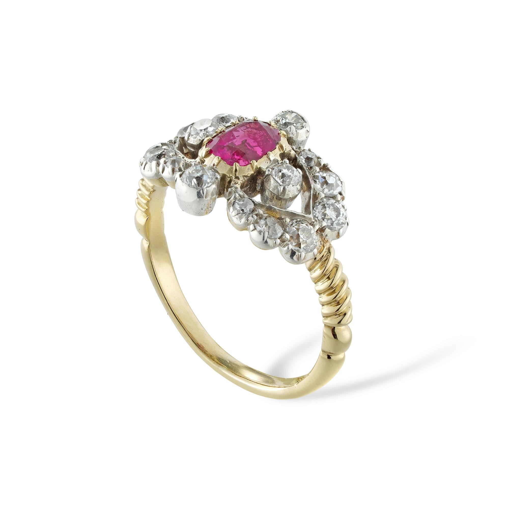 A Victorian ruby and diamond ring, to the centre a cushion-cut ruby estimated to weigh 0.65 carats, surrounded by four old European-cut diamonds, with V-shaped diamond-set sides encrusted with further twelve old-cut diamonds o graduating size, the