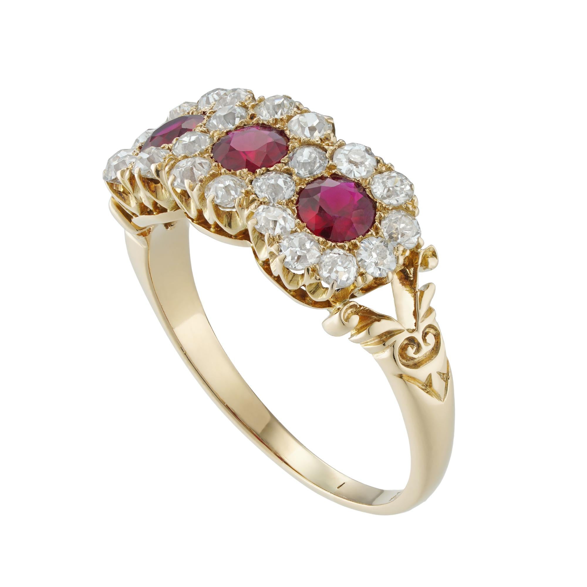A Victorian ruby and diamond triple cluster ring, the three rubies weighing 0.63 carats in total, surrounded by interlocking clusters set with twenty-four old-cut diamonds estimated to weigh 0.75 carats, all claw-set to an 18ct yellow gold mount,