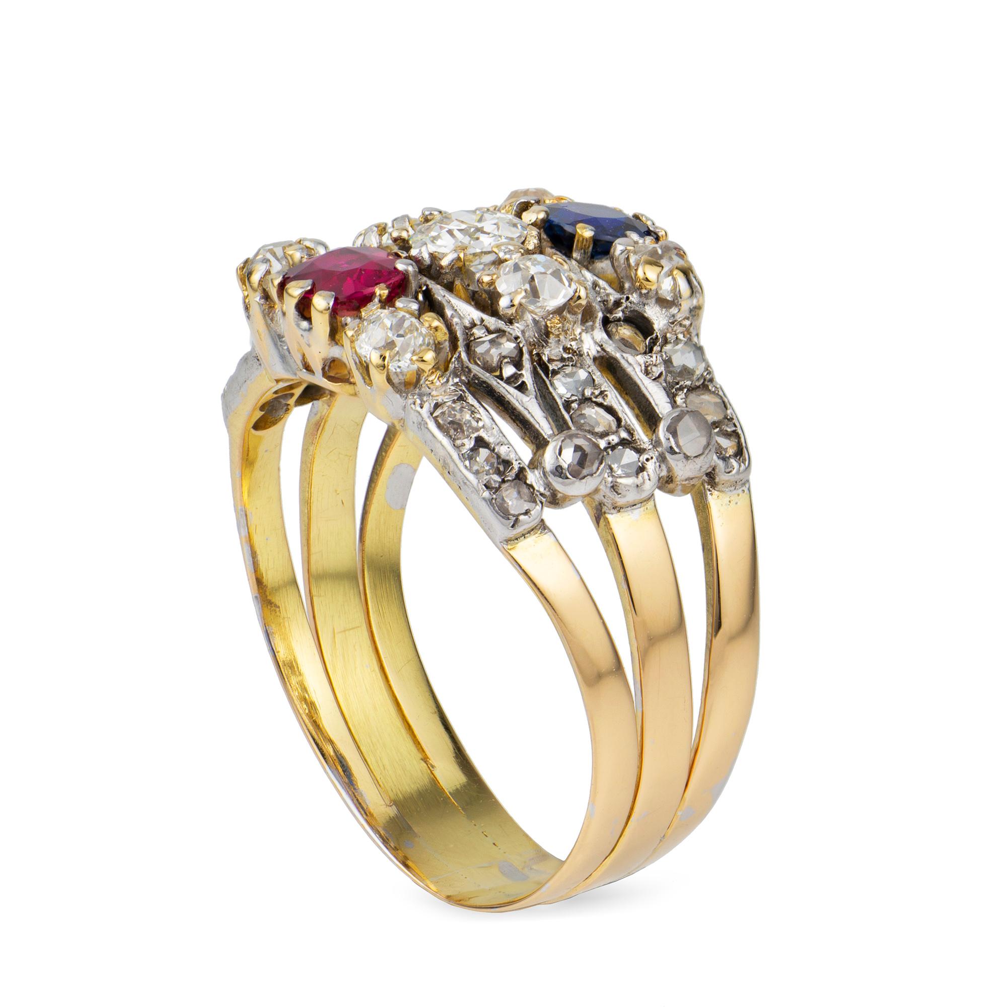 A Victorian ruby, sapphire and diamond harem ring, consisting of three bands, the one centrally-set with a ruby, the second with an old-cut diamond and the third with a sapphire, each set between two small old-cut diamonds and rose-cut diamond