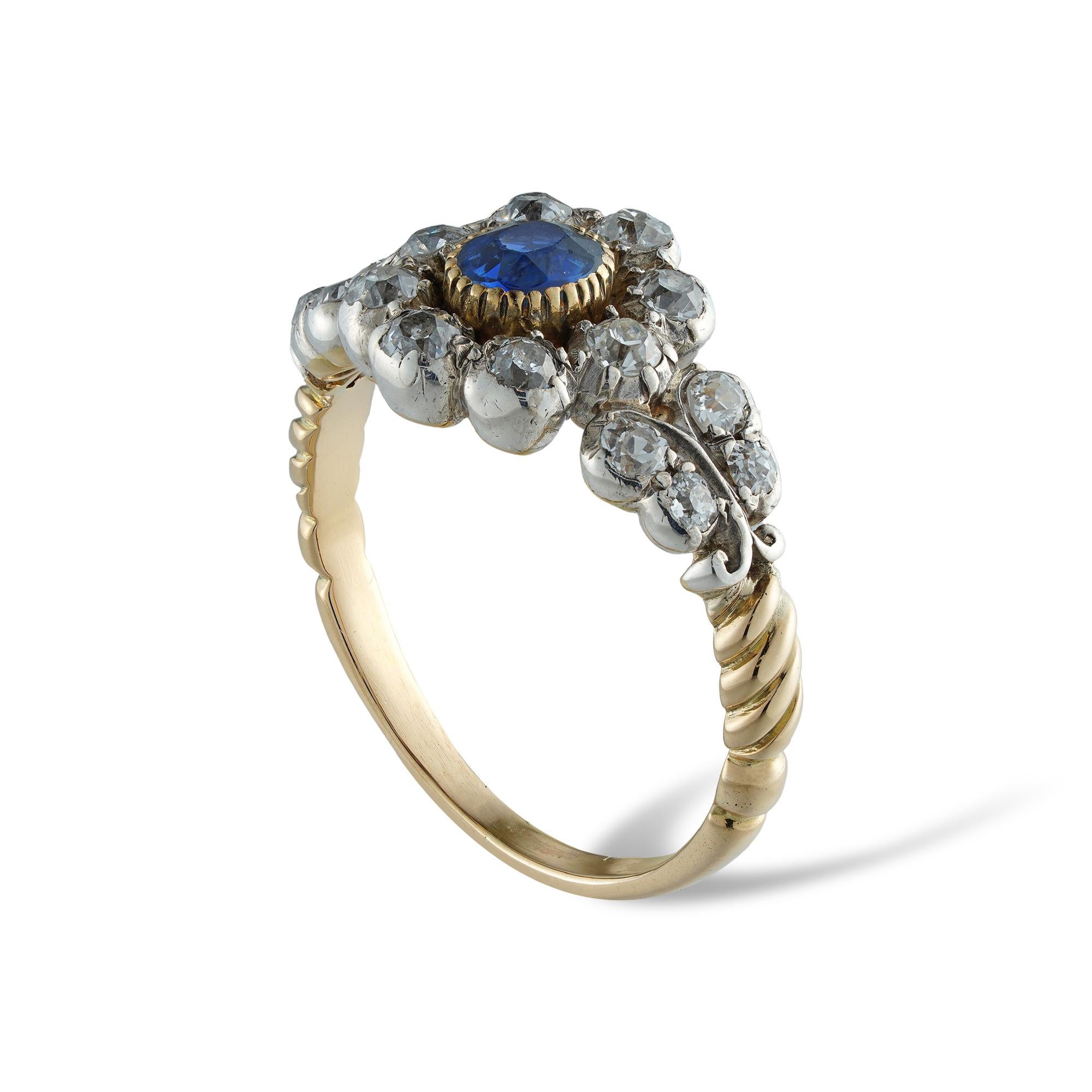 A Victorian sapphire and diamond ring, to the centre an oval-cut sapphire estimated to weigh 0.4 carats surrounded by eight old European-cut diamonds in the form of a cluster, each shoulder set with four old-cut diamonds, the diamonds estimated to