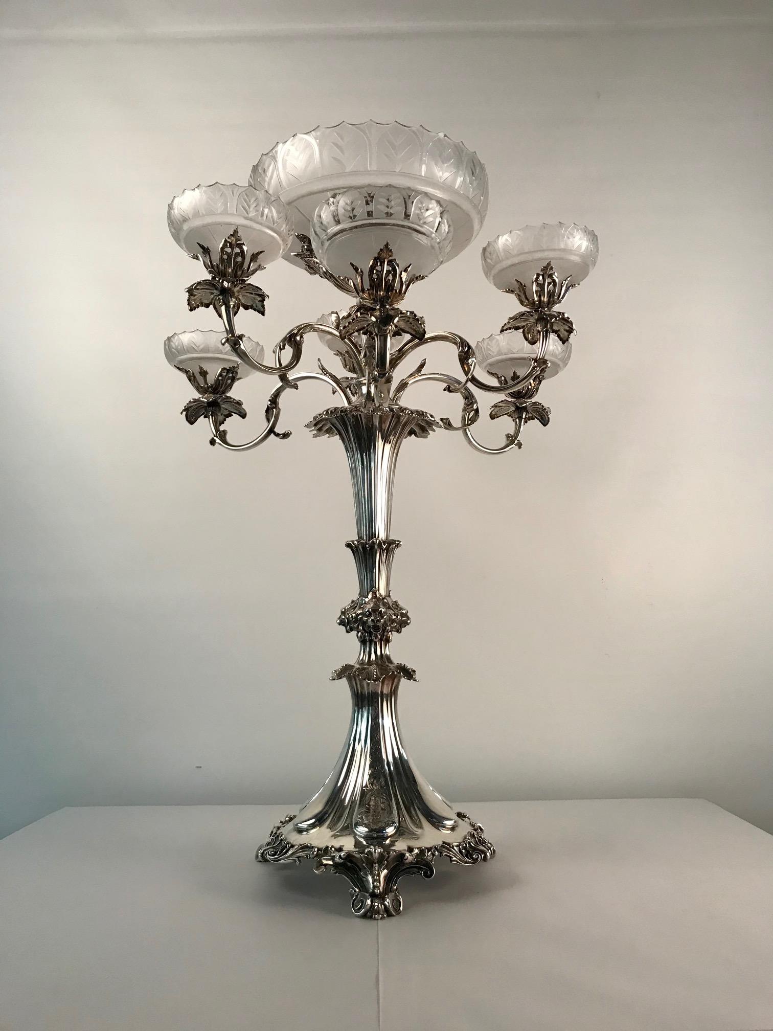 This is the largest and best centrepiece of this type that we have ever sold. It was made to Stand on a grand dining table. the six frosted and cut lead crystal bowls filled with fruit, nestled around the beautifully cut central bowl. The scrolling