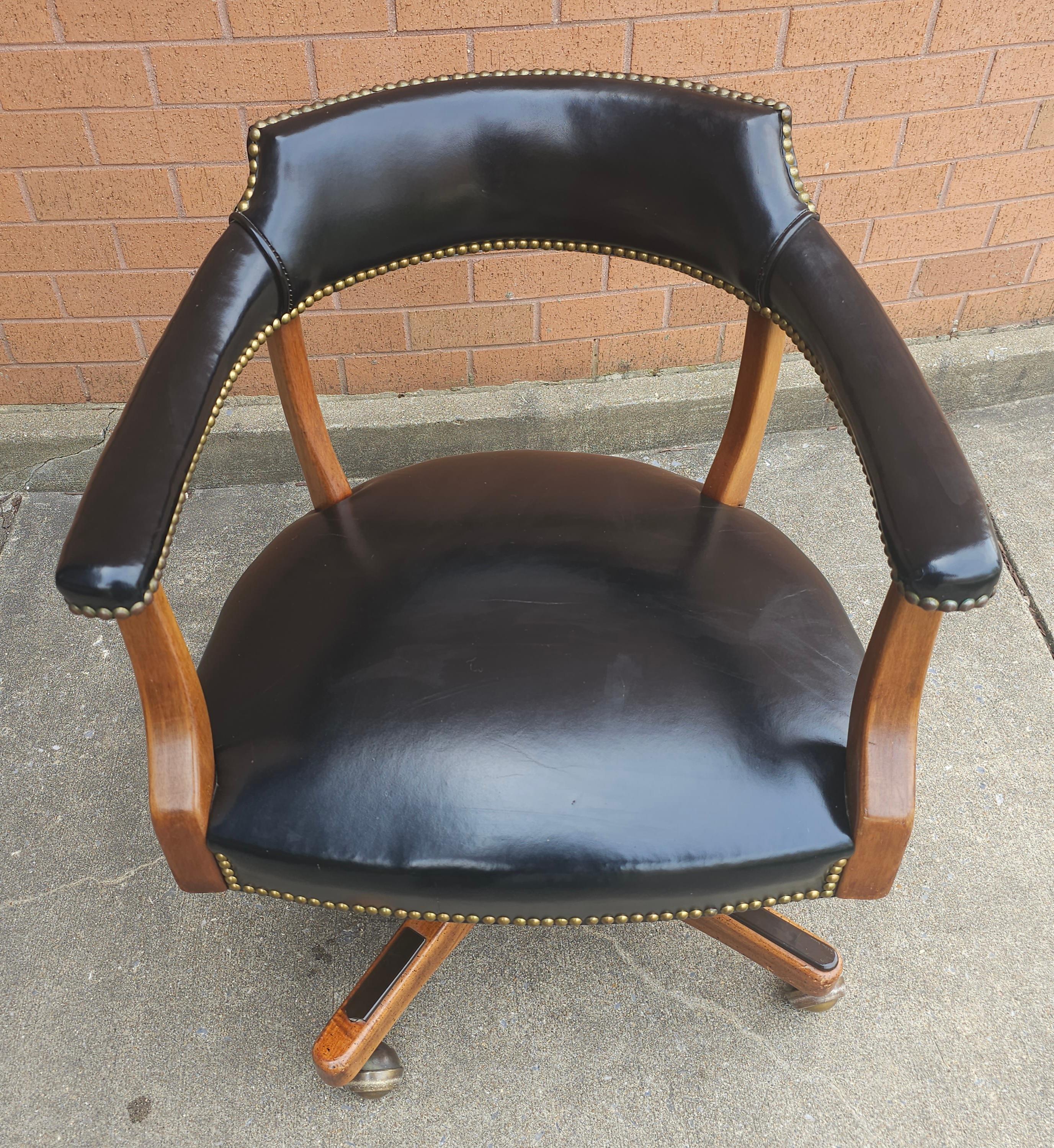 A Victorian Style Maple , Black Leather and Brass Nail Studded Rolling,  360 degree revolving and tilting Office Chair. Adjustable  seat height. Measures 24.5