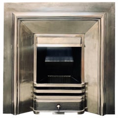 A Victorian Style Polished Cast Iron Splayed Fireplace Insert.