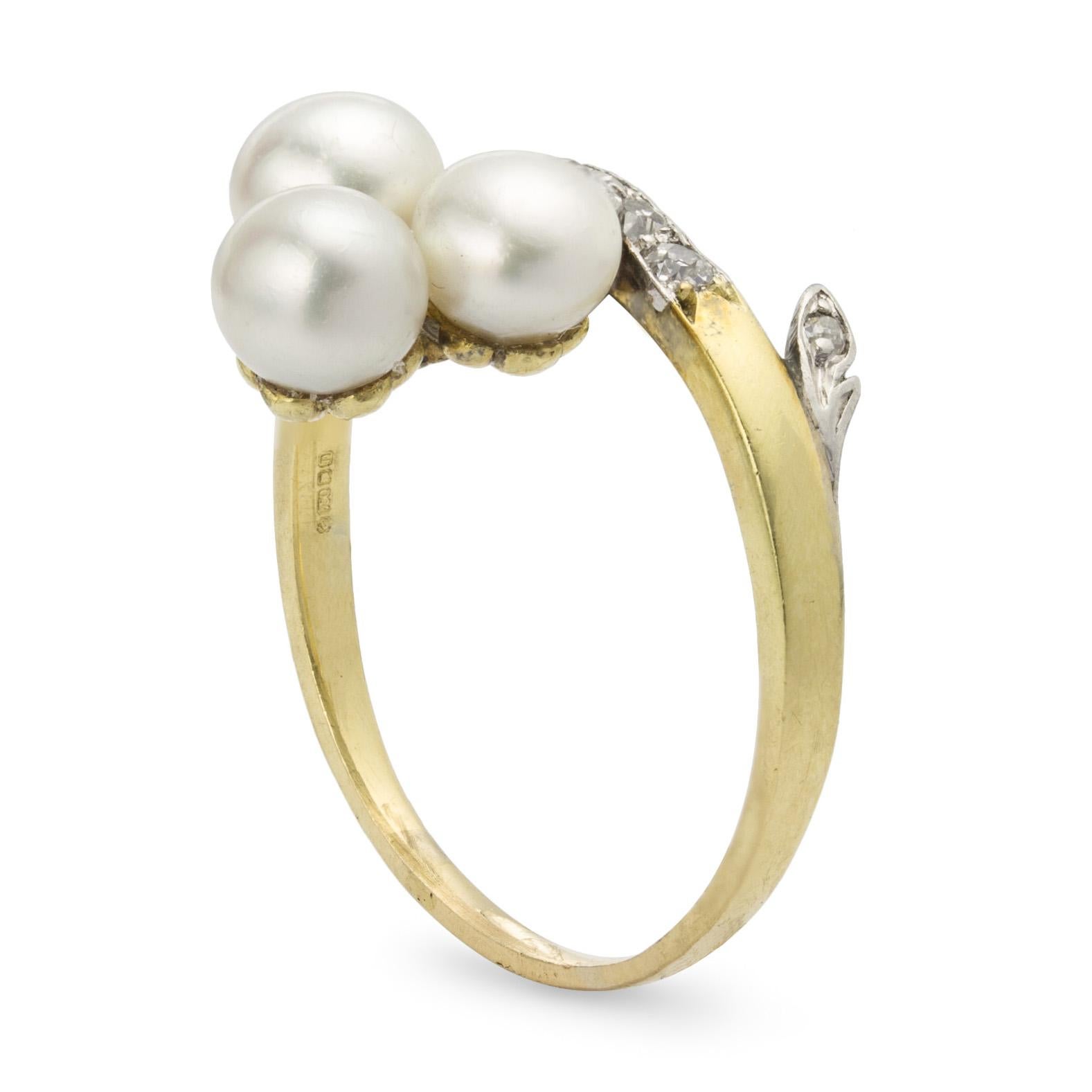 A Victorian trefoil pearl and diamond cross-over ring, the three natural pearls accompanied by an AnchorCert stating the pearls to weigh a total of 3.27 carats and to be of saltwater origin, to a branch set with old brilliant-cut diamonds, estimated