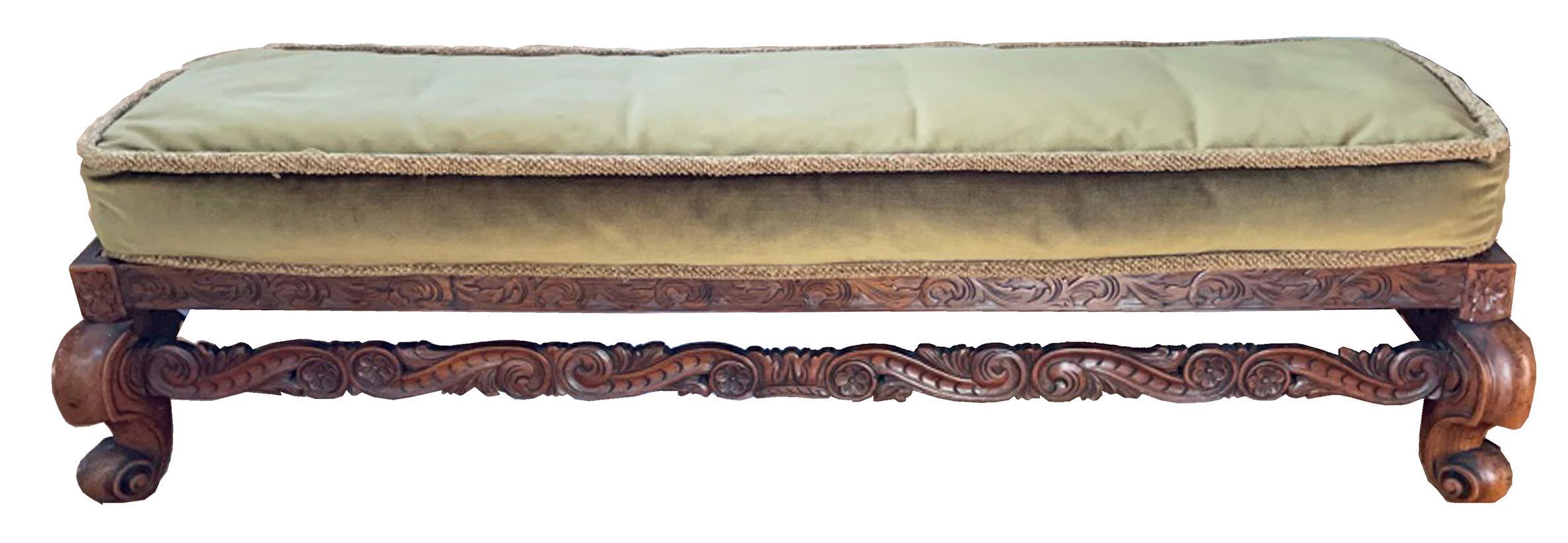 A Long-low foot stool/dog bed
Solid hand-carved walnut with cane seat and sage green velvet cushion, Ca 1900
 13” high
15” deep
50” long 