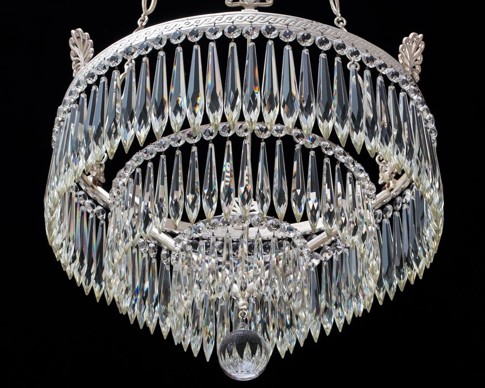 A silver plated Victorian waterfall chandelier suspended on three decorative chains to the main band issuing six anthemions and three concentric rings hung with icicle drops and ball finial.