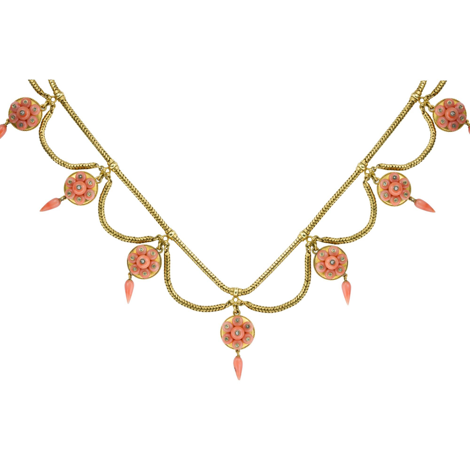 A Victorian coral and diamond yellow gold swag necklace, the necklace comprising twelve circular plaques, each set with a cluster of seven coral beads, each set with an applied diamond to the centre, all to a yellow gold backing with fine rope