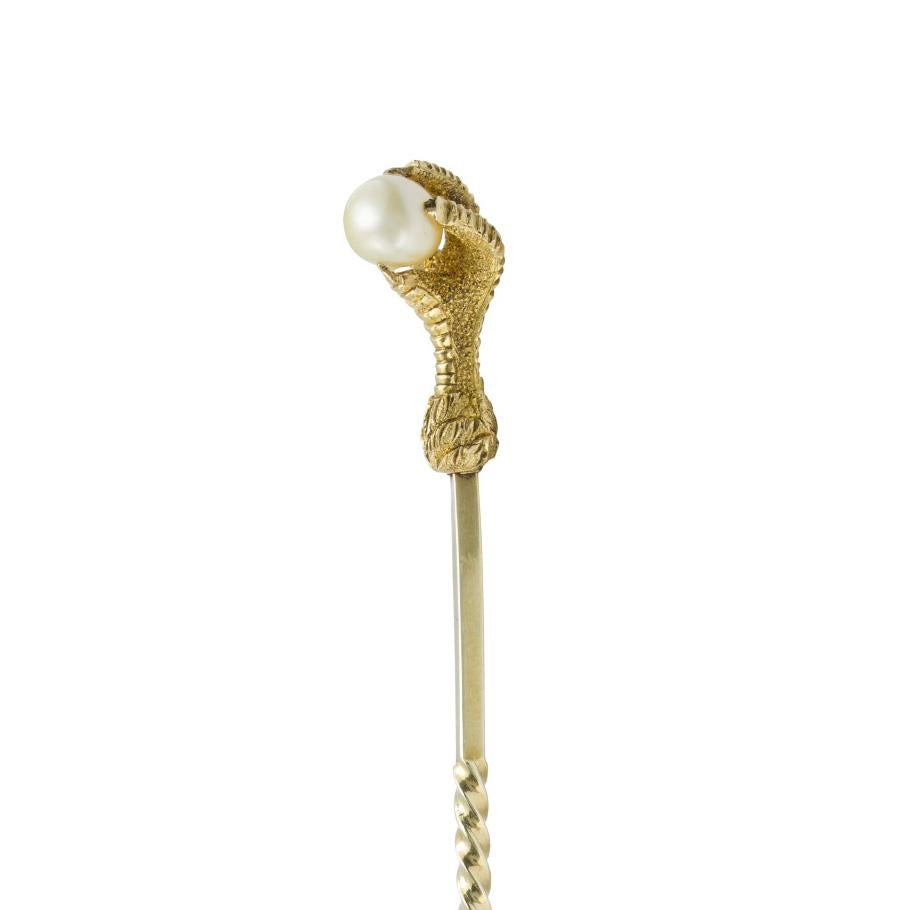 A Victorian yellow gold and pearl talon stick-pin, the yellow gold pin terminating in a realisticaly carved eagle’s talon claw with scale and feather details, holding a pearl measuring approximately 6.1x5.5x5.0mm, accompanied by GCS report 78161-86