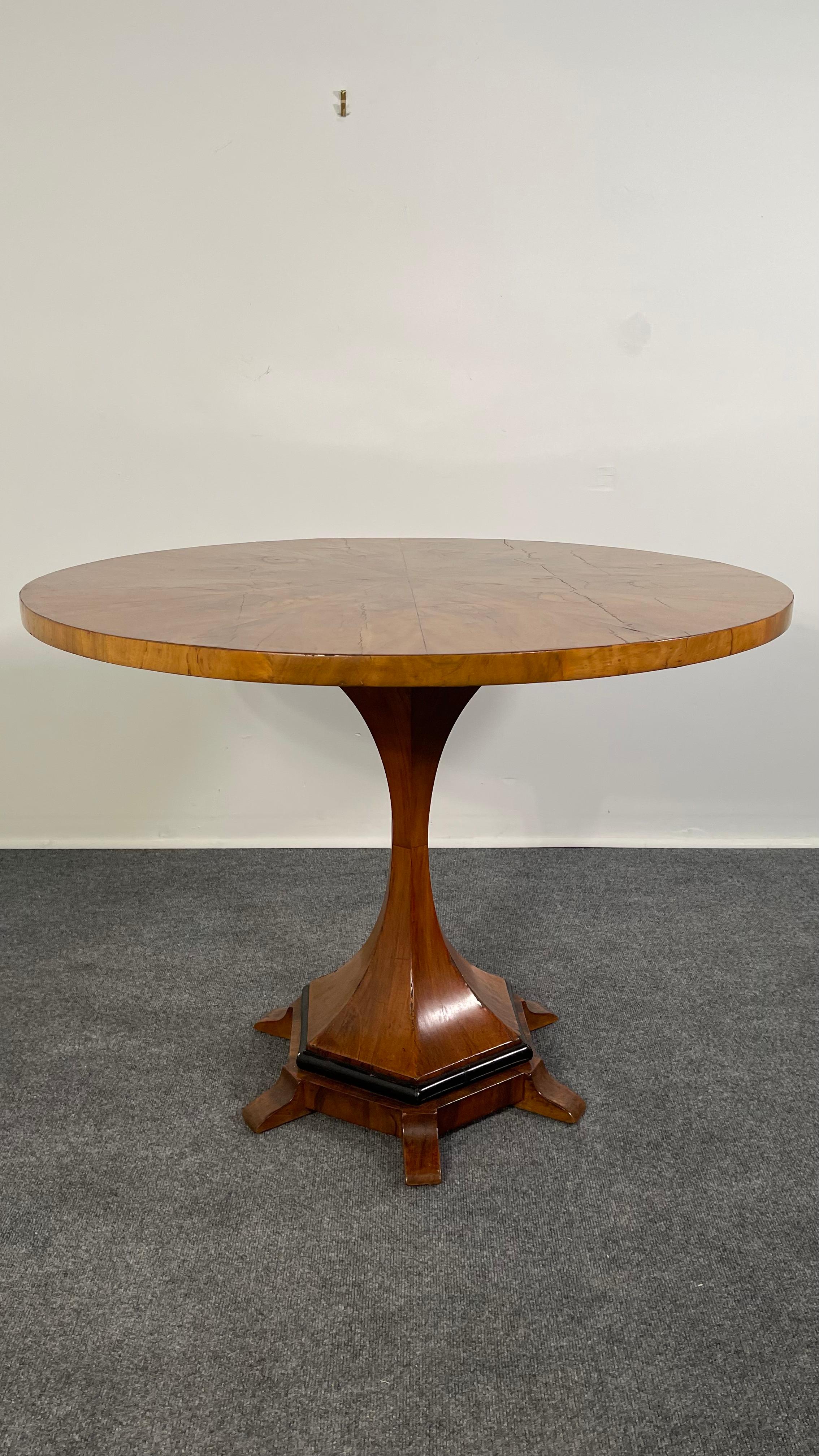 The circular top with highly figured veneer over a columnar support, terminating in a hexagonal base with 6 feet.