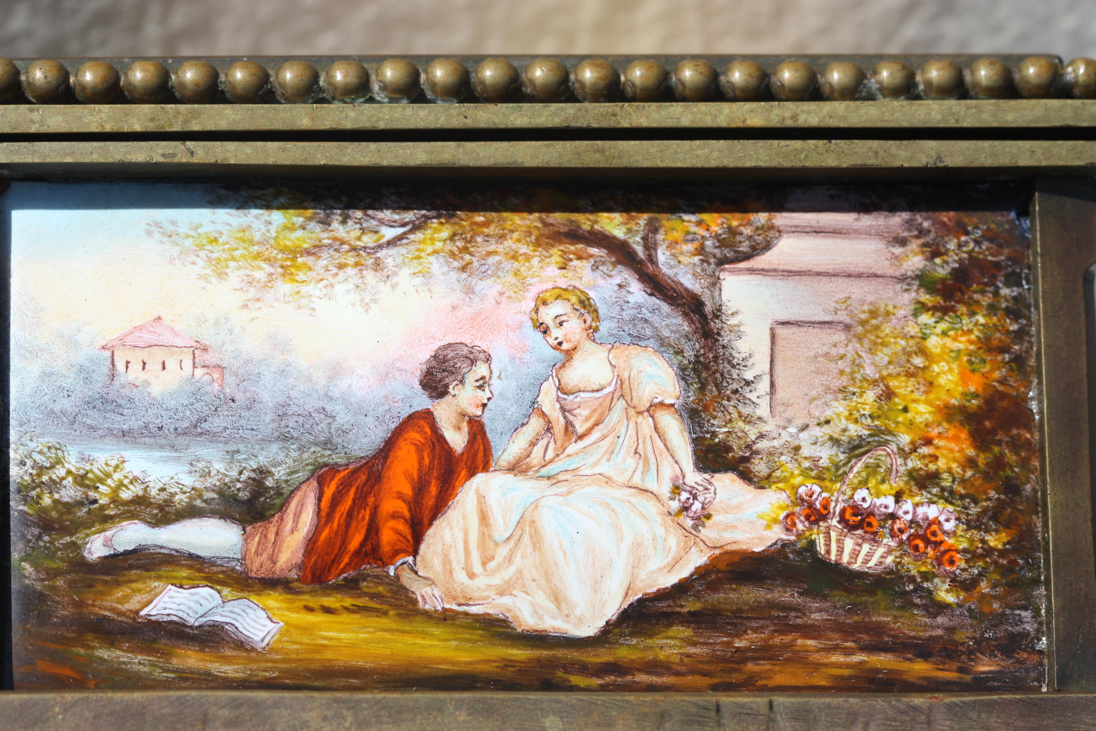 A Viennese enamel & bronze box. Decorated with five romantic panels. 
Measures: Height 3 in. (7.62 cm.), 
Width 4.75 in. (12.06 cm.), 
Depth 3.5 in. (8.89 cm.).
  