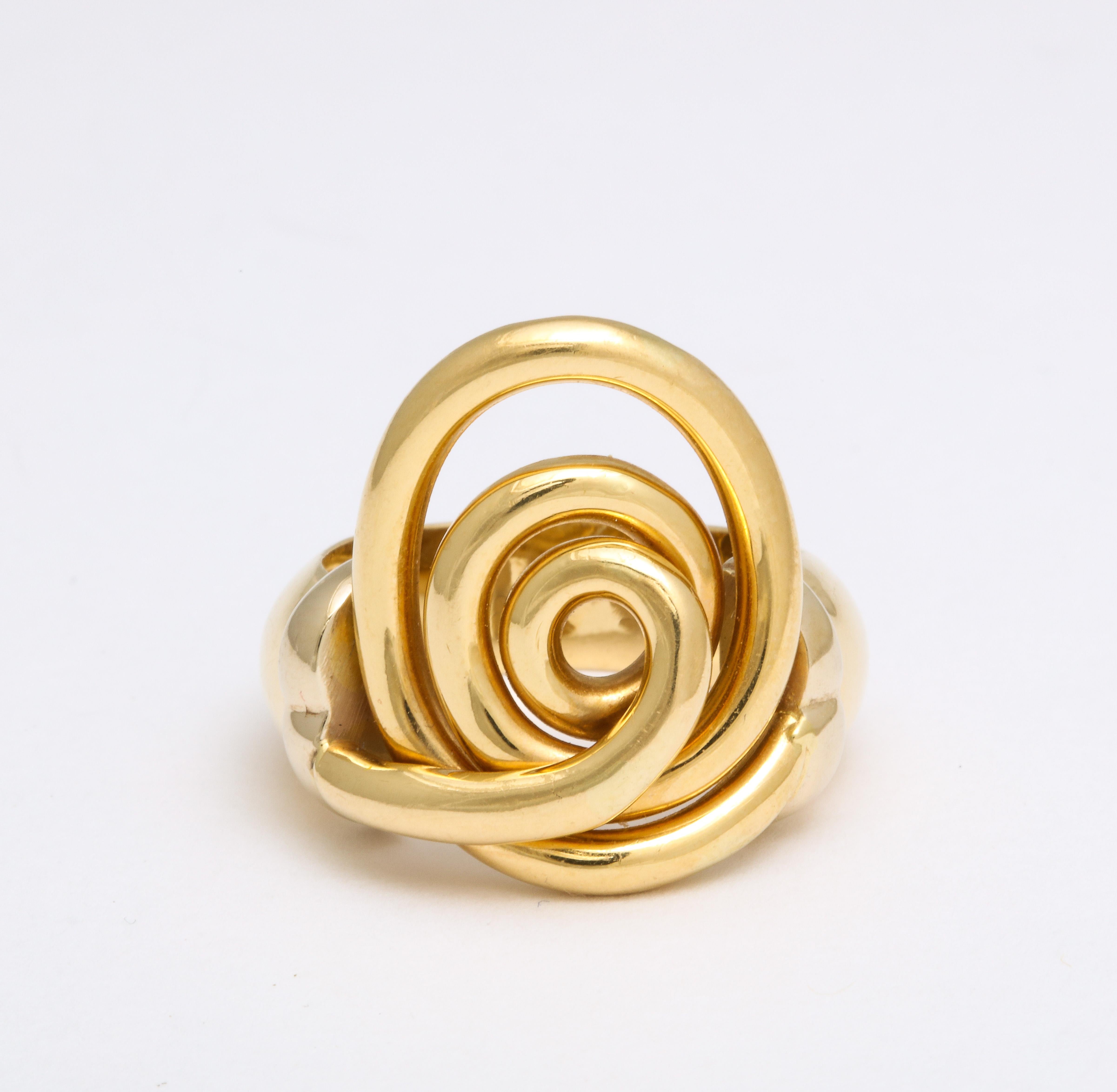 Representing the circle of life, regeneration and evolution of the spirit, the spiral ring in 18 Kt gold has a positive symbolic meaning as well as being an unusual fashion ring. It is a remarkable statement ring that fits the 1970's esthetic,