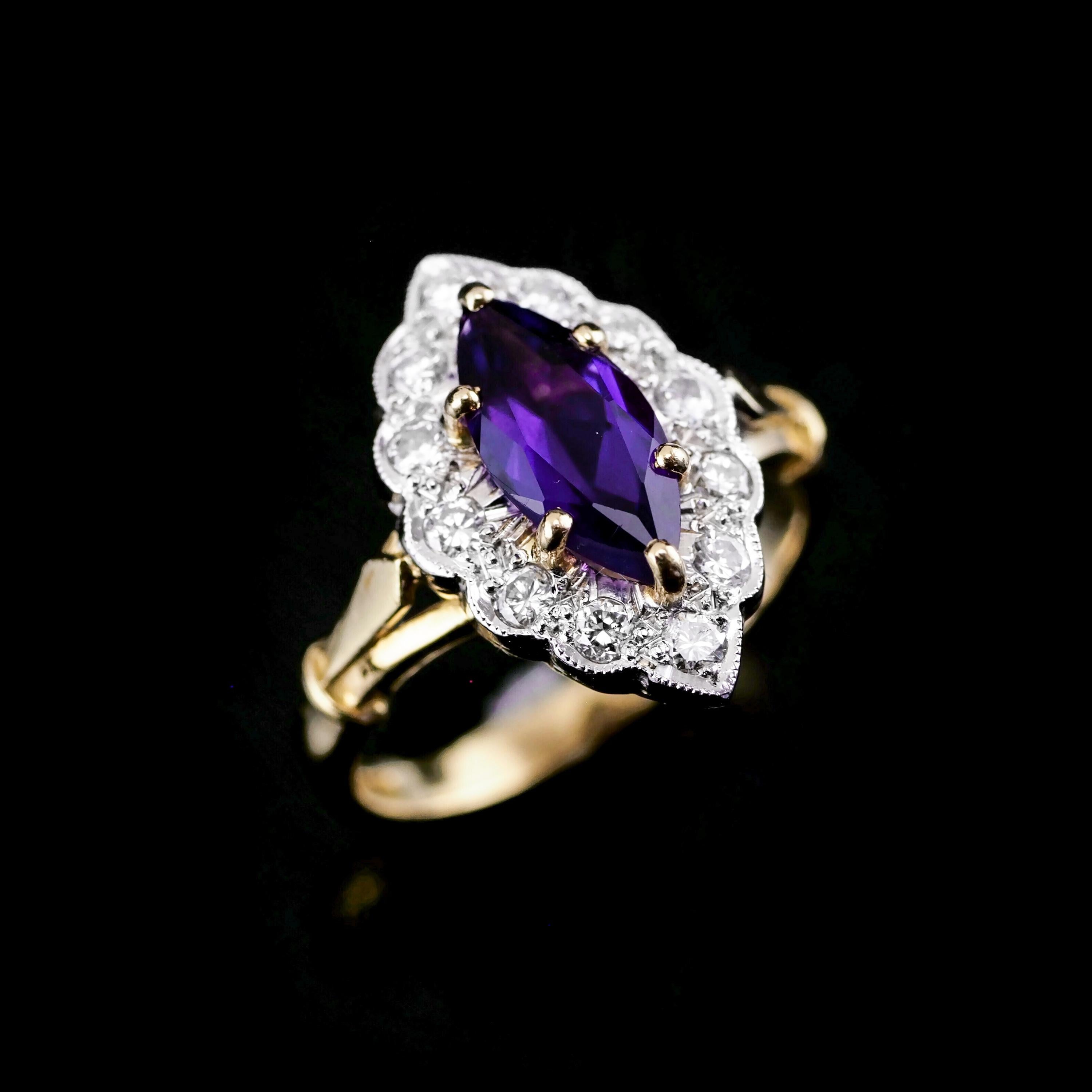 We are delighted to offer this wonderful vintage 18K gold amethyst & diamond marquise ring.

The ring features a magnificent large central amethyst (marquise cut 10mm x 5mm) with a nice deep rich purple hue.

The central amethyst is flanked by 12