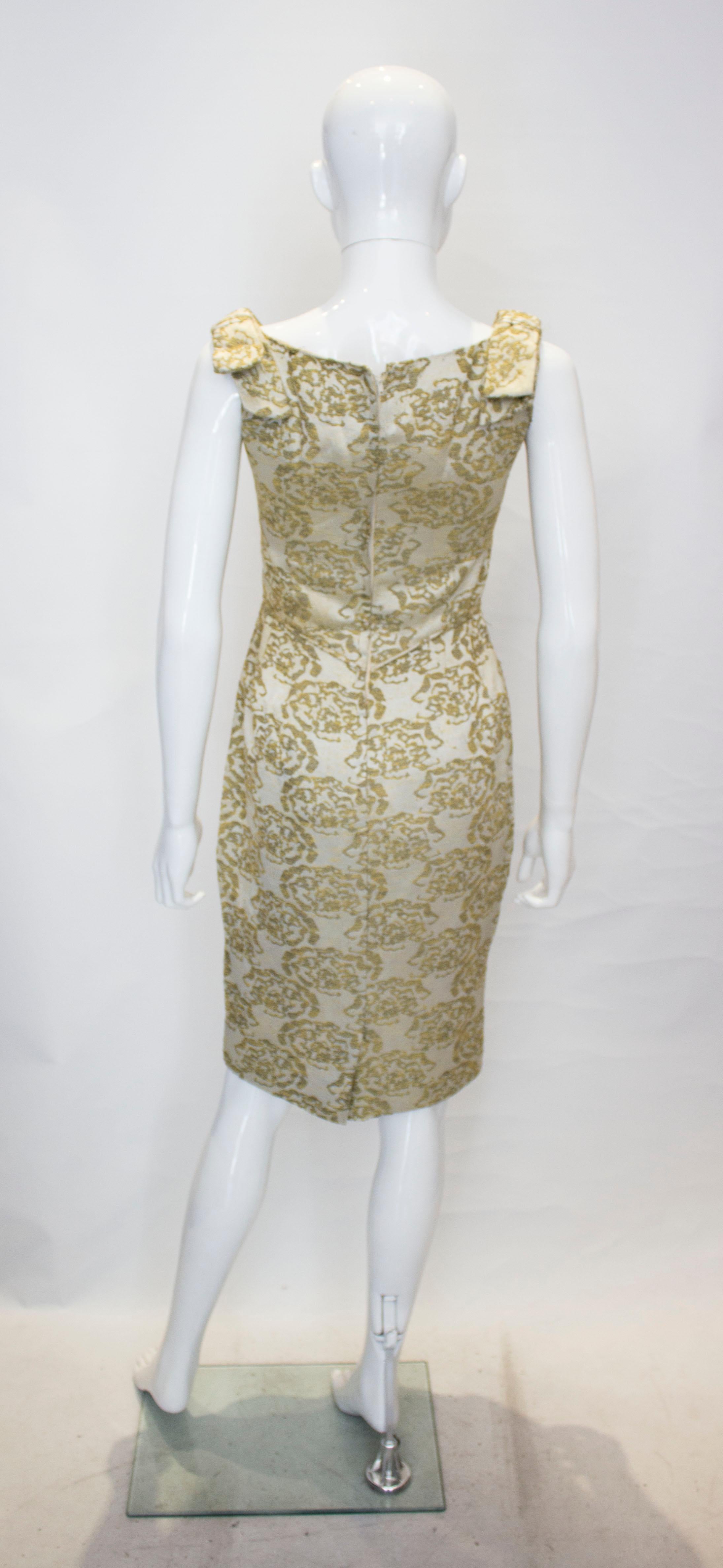 A vintage 1950s - 1960s olive green & gold brocade cinch wiggle cocktail dress  1