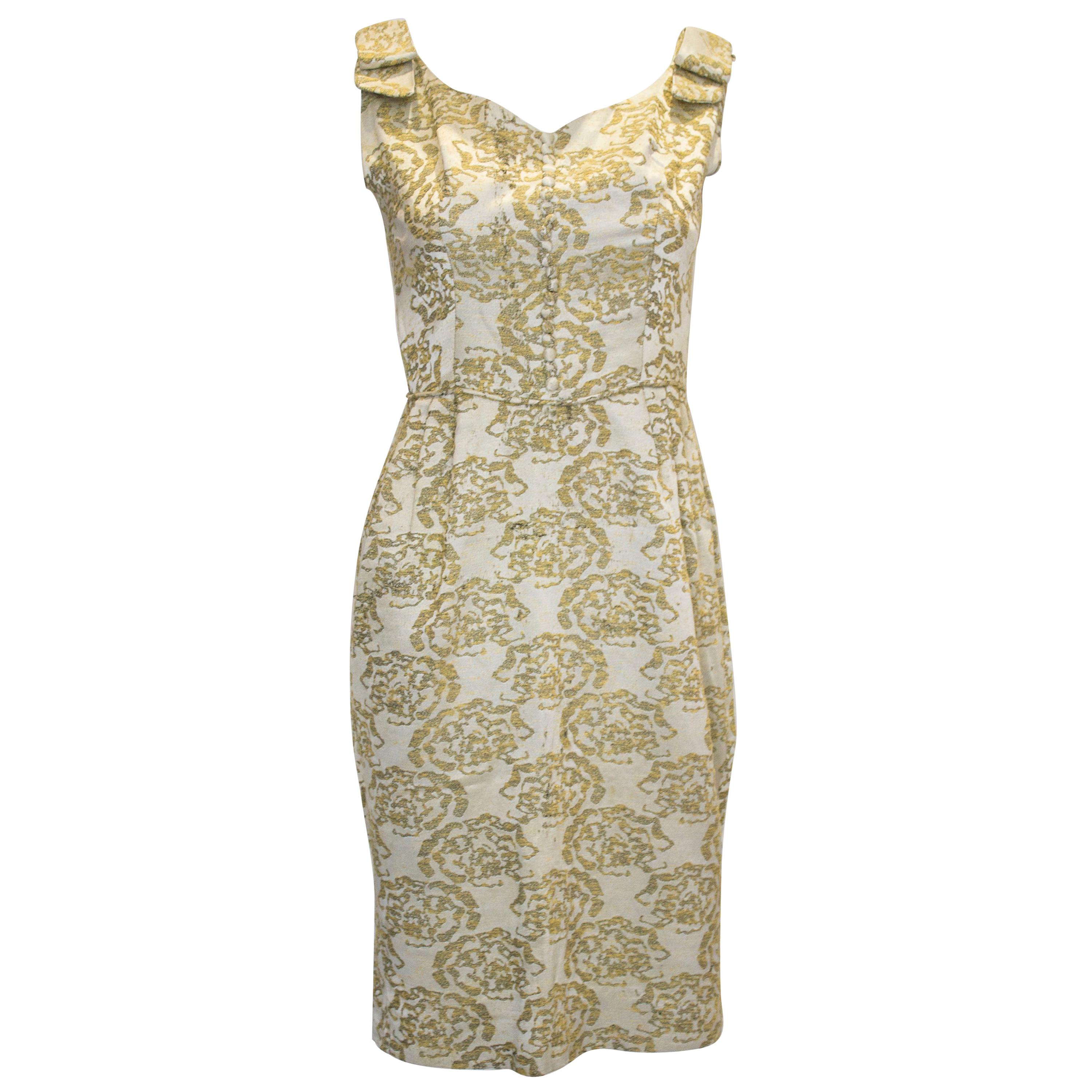 A vintage 1950s - 1960s olive green & gold brocade cinch wiggle cocktail dress 