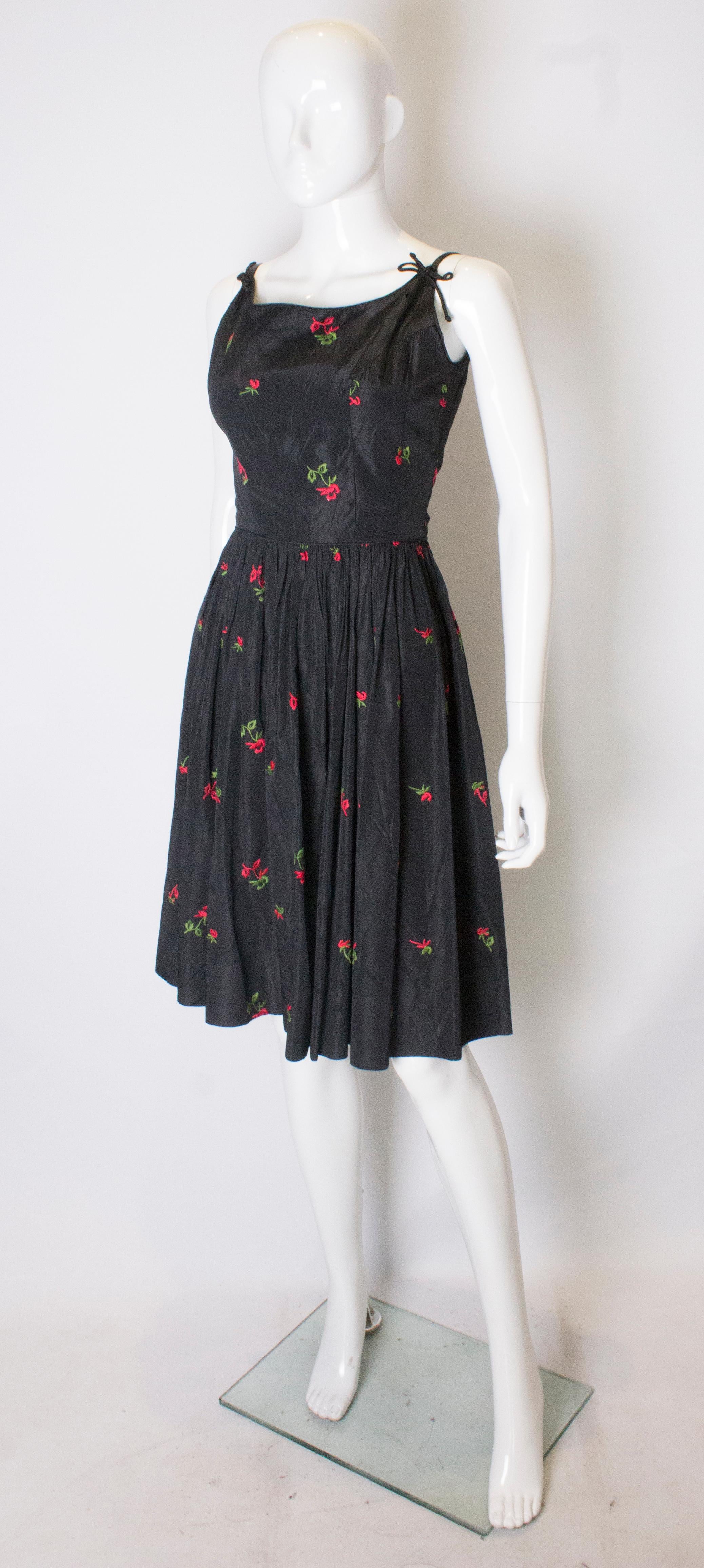 black dress with embroidered flowers
