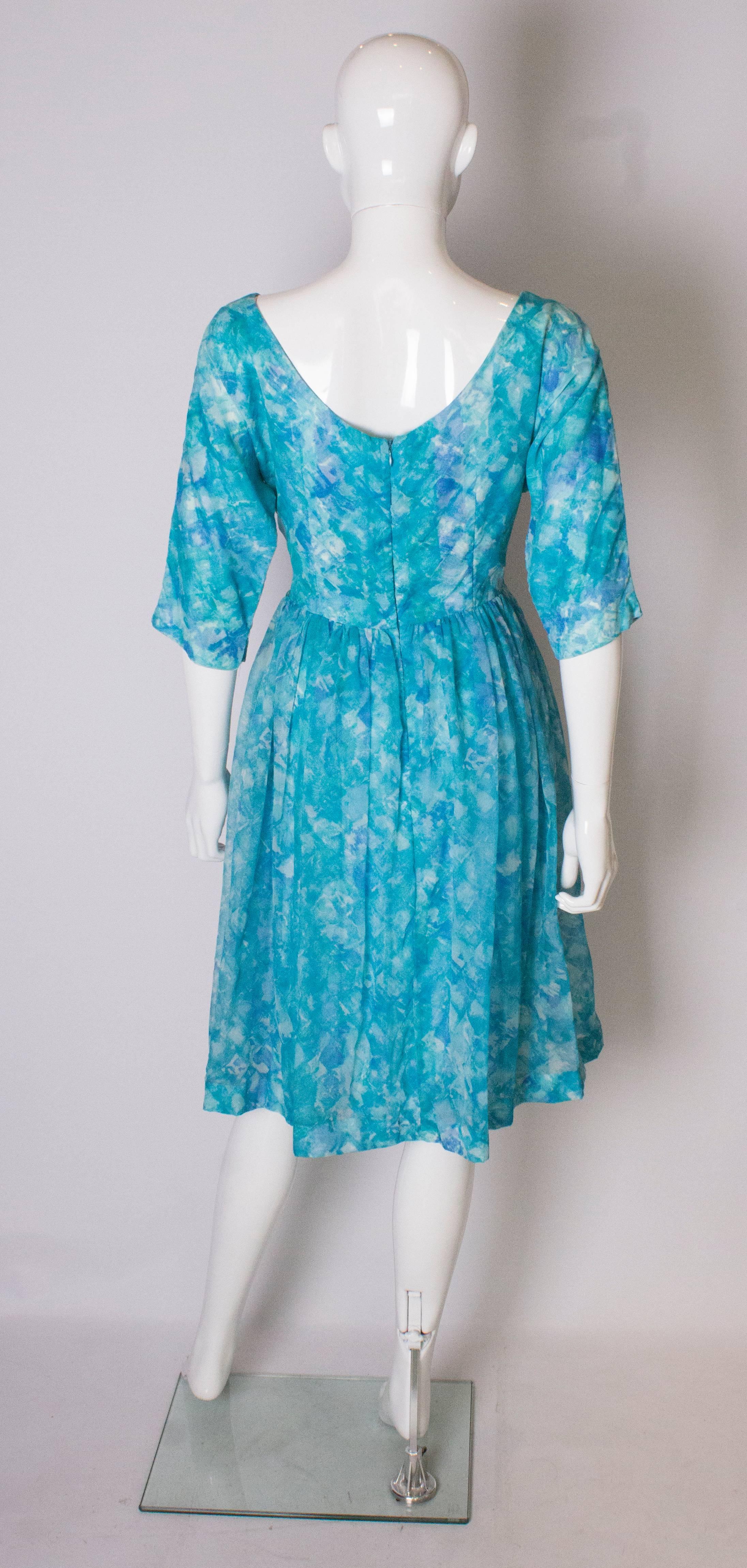 A Vintage 1950s  swing cinch cocktail dress with pleated skirt In Good Condition For Sale In London, GB