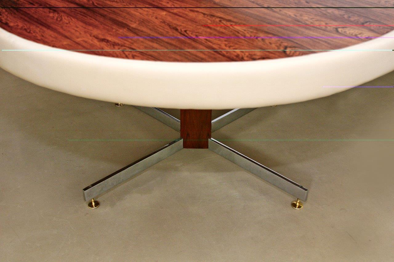 A 1960s round table by the famous artist Jorge Zalszupin with a square jacaranda central base and polished brass crosslet feet. The top with a Pau Ferro veneer and the table´s edge leather-upholstered.