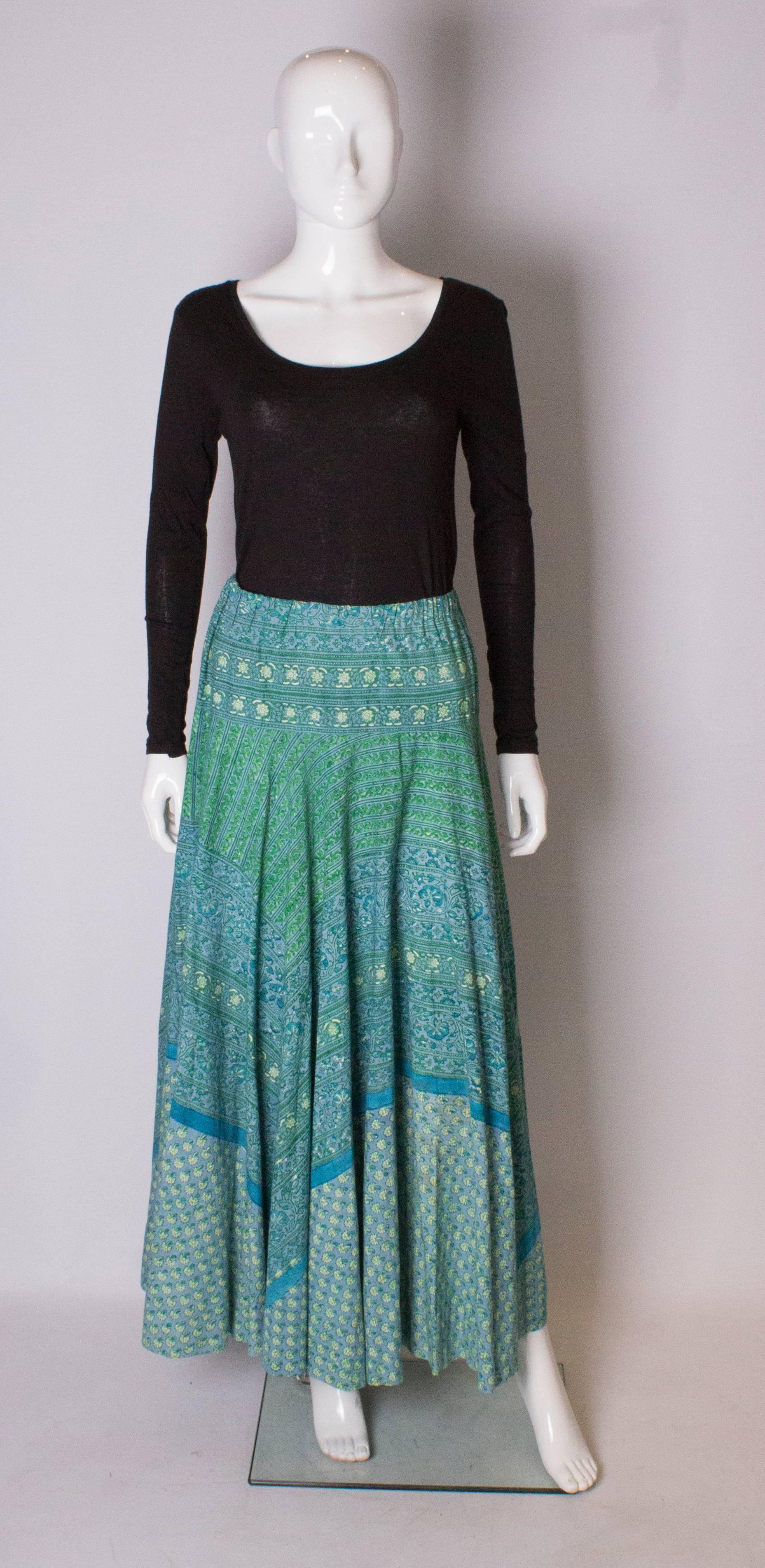 A great vintage skirt for summer.  In a floral printed cotton with an elasticated waist , the skirt is wonderful mixture of greens and blues.
 The waist  measures 28/30 '' with some stretch, and the length is 40''