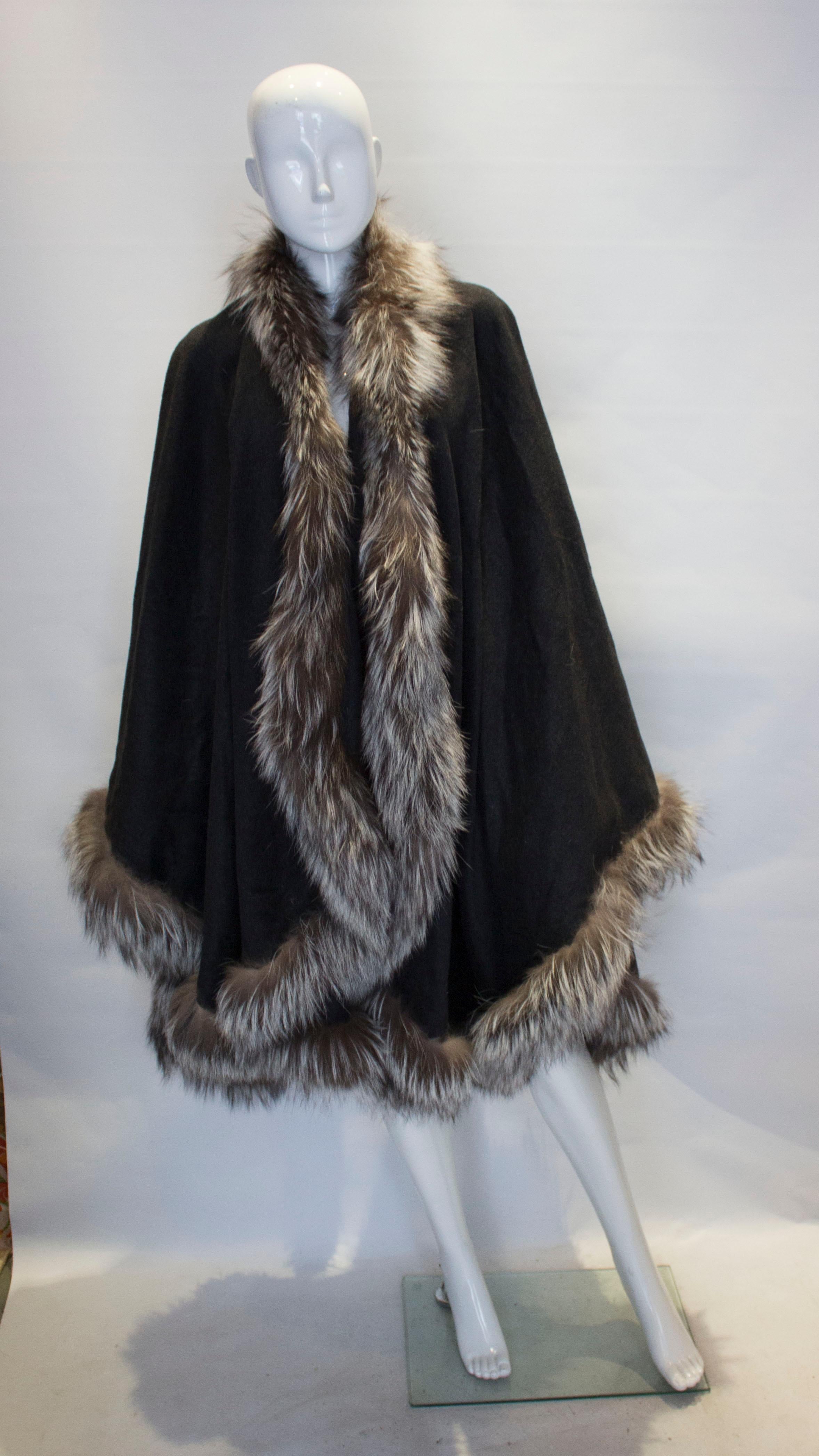 Great for Fall/Winter this grey wool wrap has a wonderful fox fur trim, in shades of brown and ivory.
