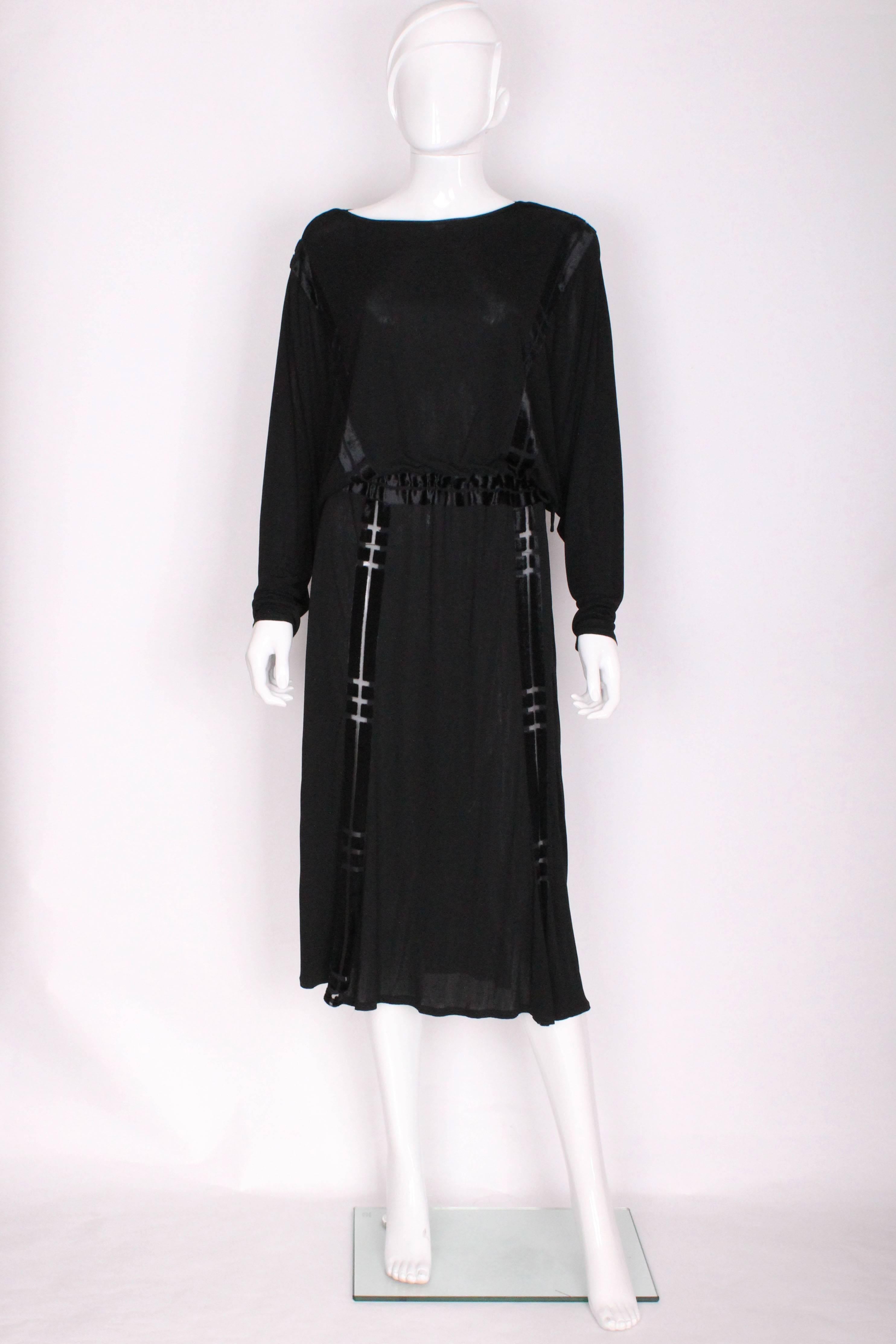 A great cocktail dress by British designer Janice Wainwright.In viscose with velvet detail in geometric blocks.The dress is marked size 16 ( an old size 16) but has a drawstring waist , so can fit various sizes.