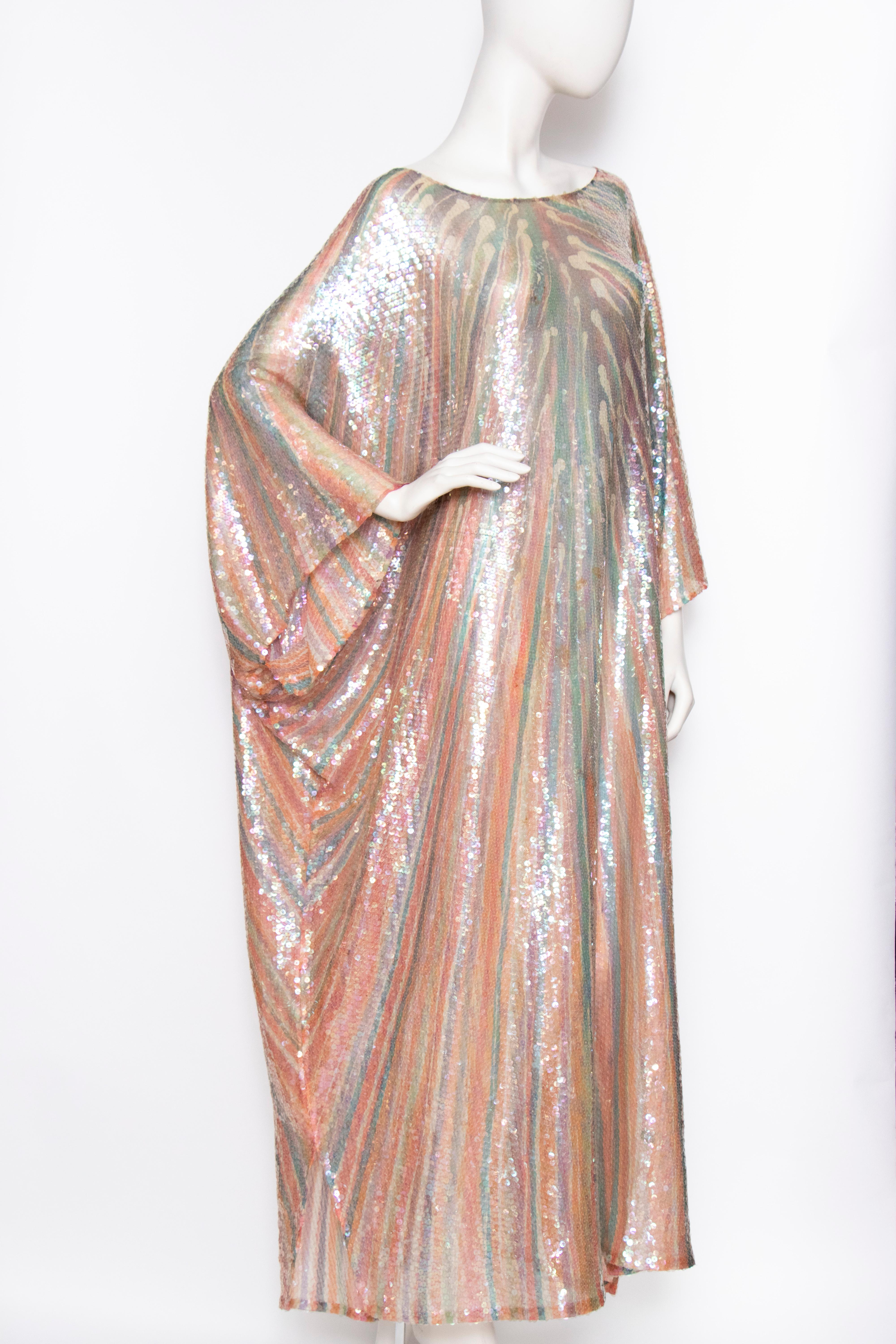 An incredible 1970s sheer Halston silk caftan dress with a round neckline covered in clear sequins. 
