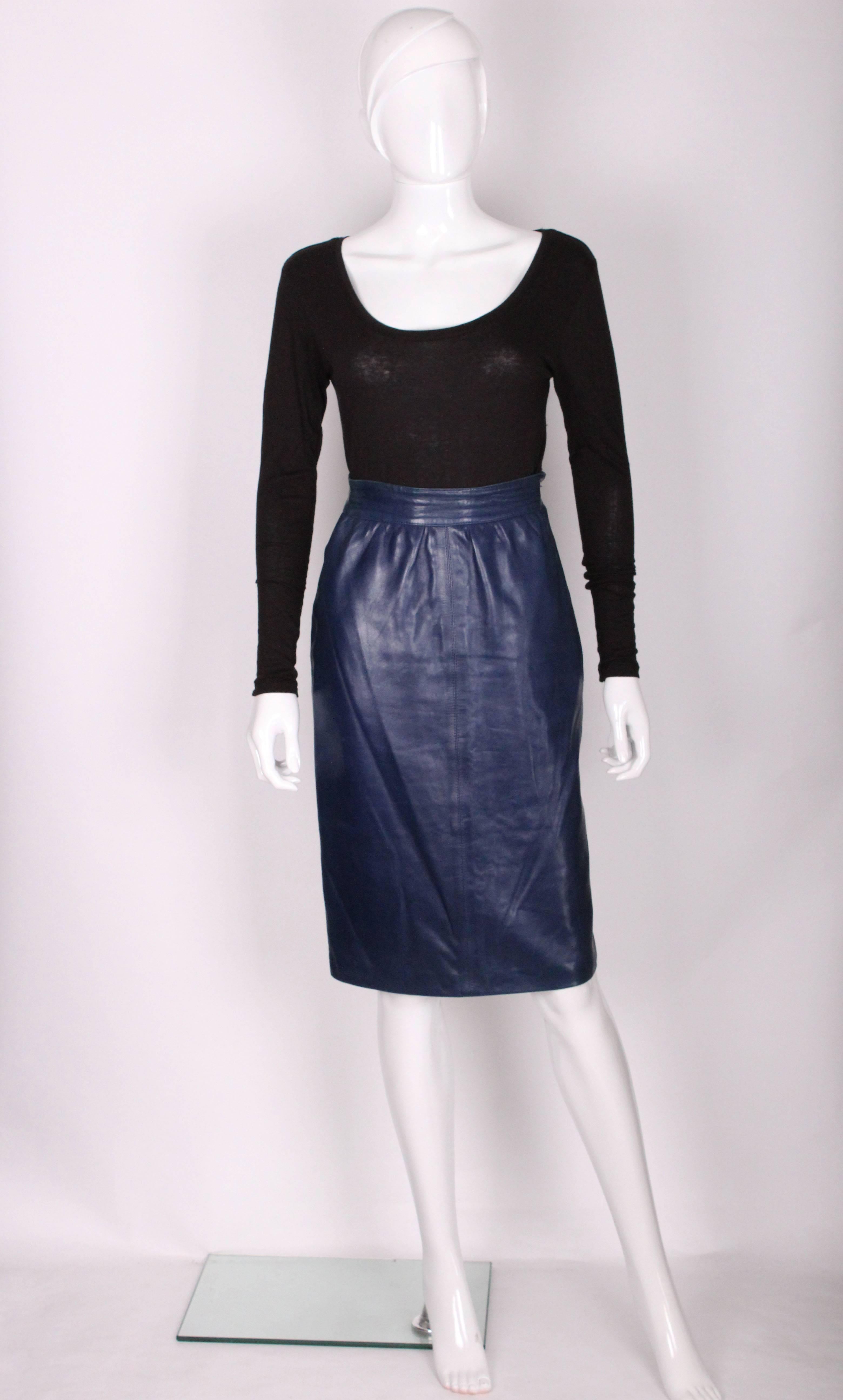 A stunning and very soft leather skirt by Yves Saint Laurent, Rive Gauche line.
In a brilliant blue colour , this skirt has a side zip and button opening ,and a 7'' central back slit .