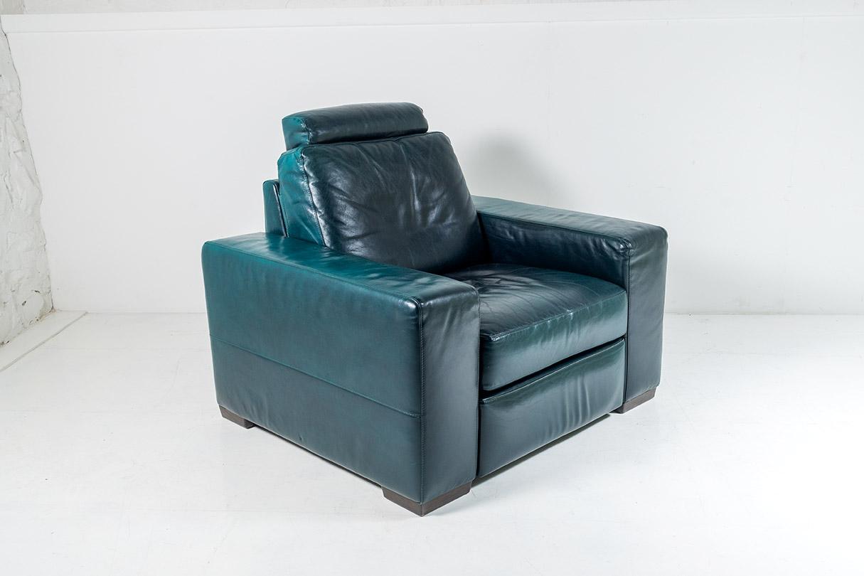 A vintage, circa 1980s leather recliner armchair in a fabulous green colour. A generously proportioned and comfortable chair with a strong design, a well made piece with heavy form and good strong mechanism. The reclining action has a smooth