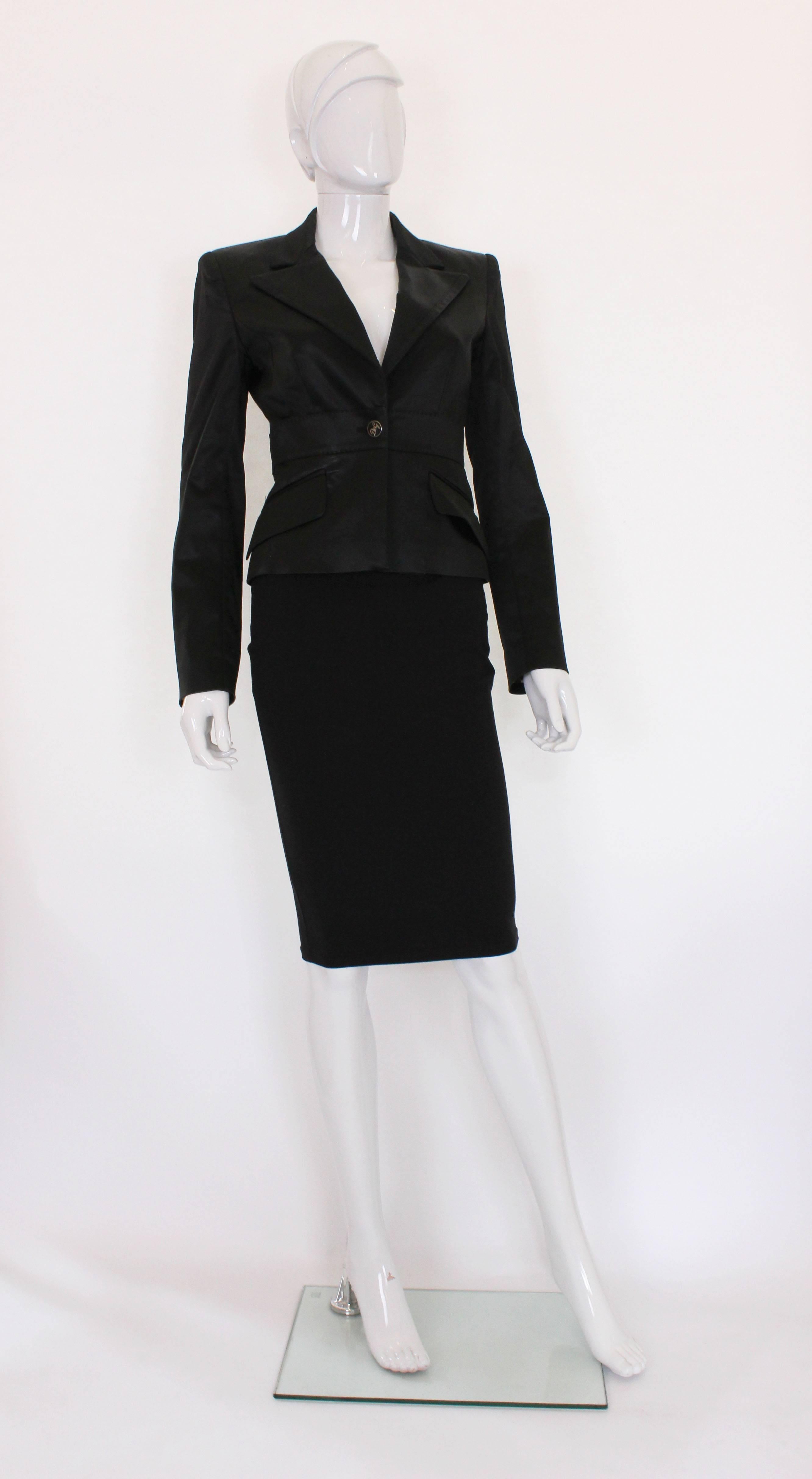 
A chic evening jacket from Italian design team, Dolce and Gabbana.In a black satin like fabric,this jacket has a cutaway collar with stitch detail,2 waist leval pockets , a central button fastening and three buttons on each cuff.
