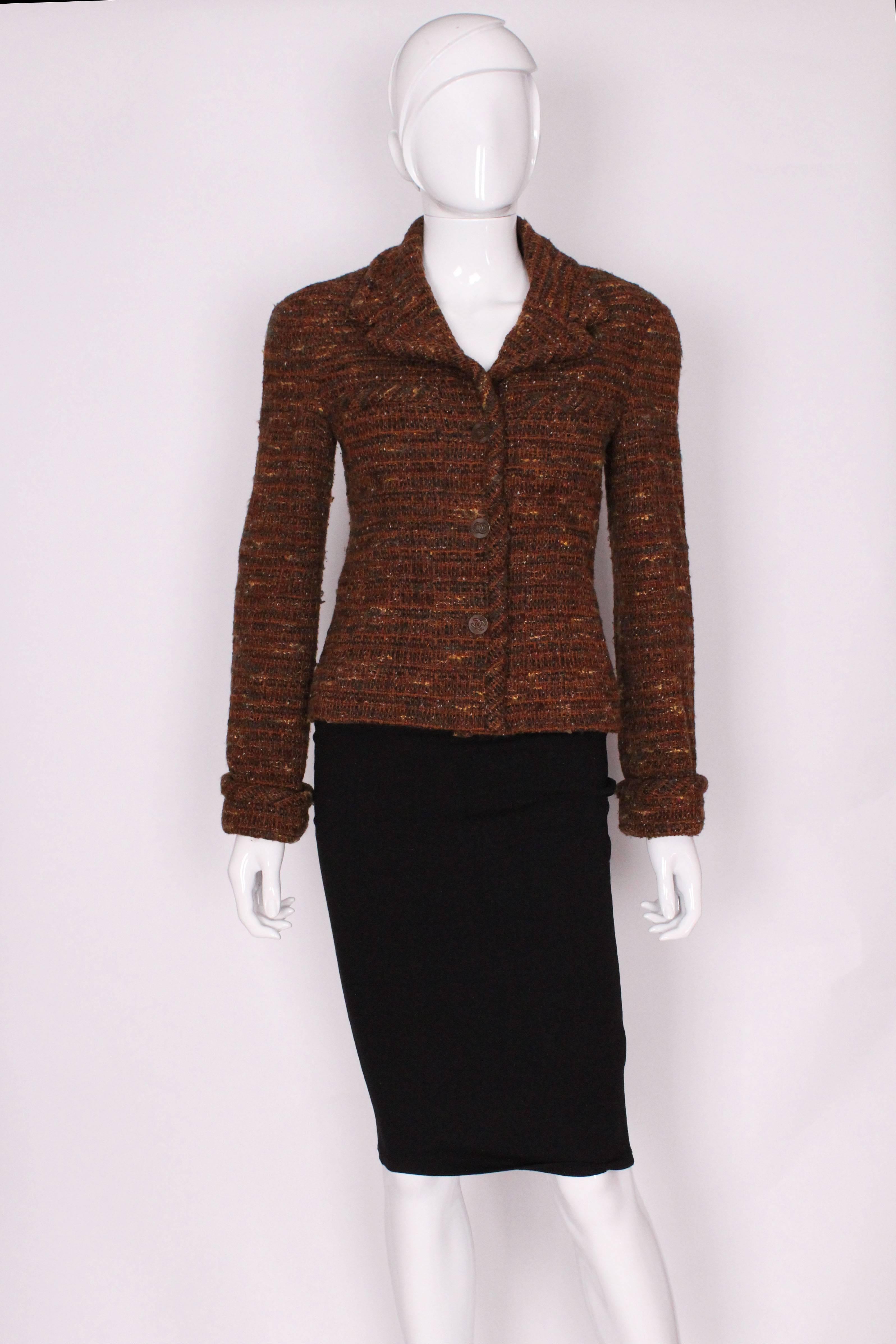 A great jacket for Fall. This jacket by Chanel  (1998A), is in a wonderful mix of Autumn colours, brown with flecks of dark brown, green ,red ,gold and white.
The outer fabric is 80% wool, 20% Acrylic, the lining is 100% silk, with a chain running