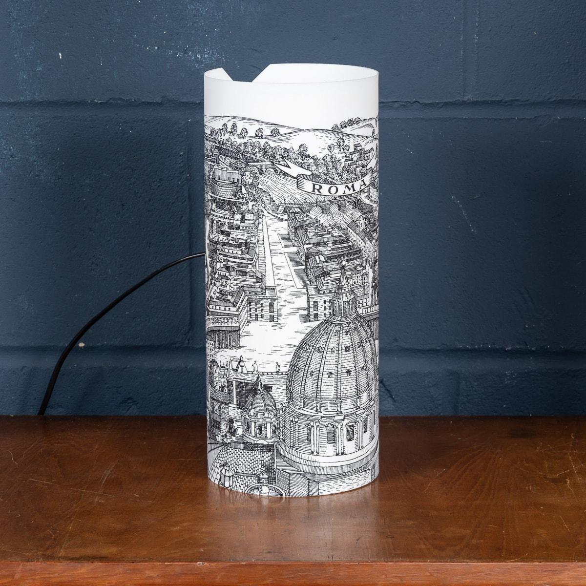 A beautiful table lamp by Piero Fornasetti. This particular model retailed by Antonangeli in the 1990s, now discontinued and appreciating in value. More importantly it gives any room a very chic twist on lighting with its plexiglass structure with