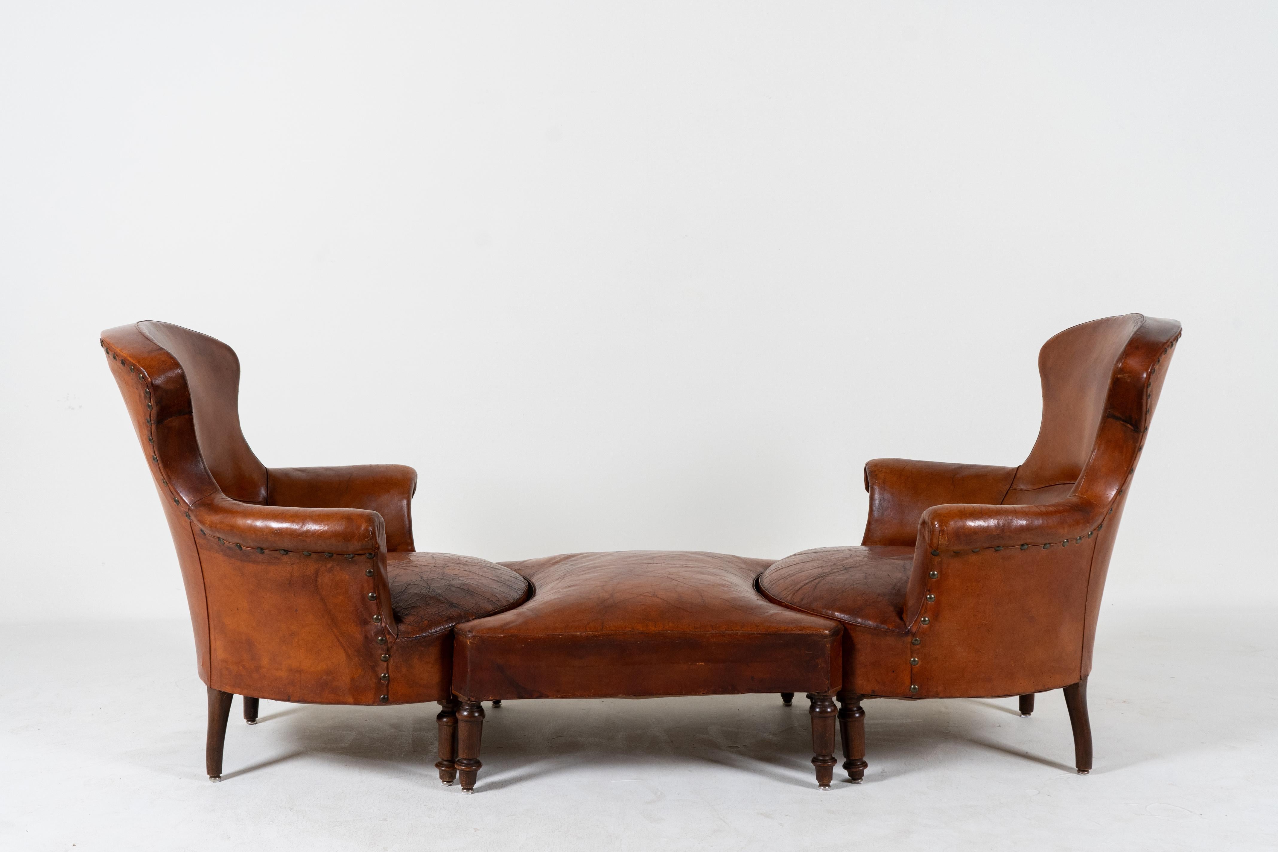 A rare 3-piece French leather chaise lounge set with two chairs and a specially-fitted joining stool.  This is one of the more unusual French leather chair sets we've come across.  Each chair is quite comfortable and desirable on its own, with a