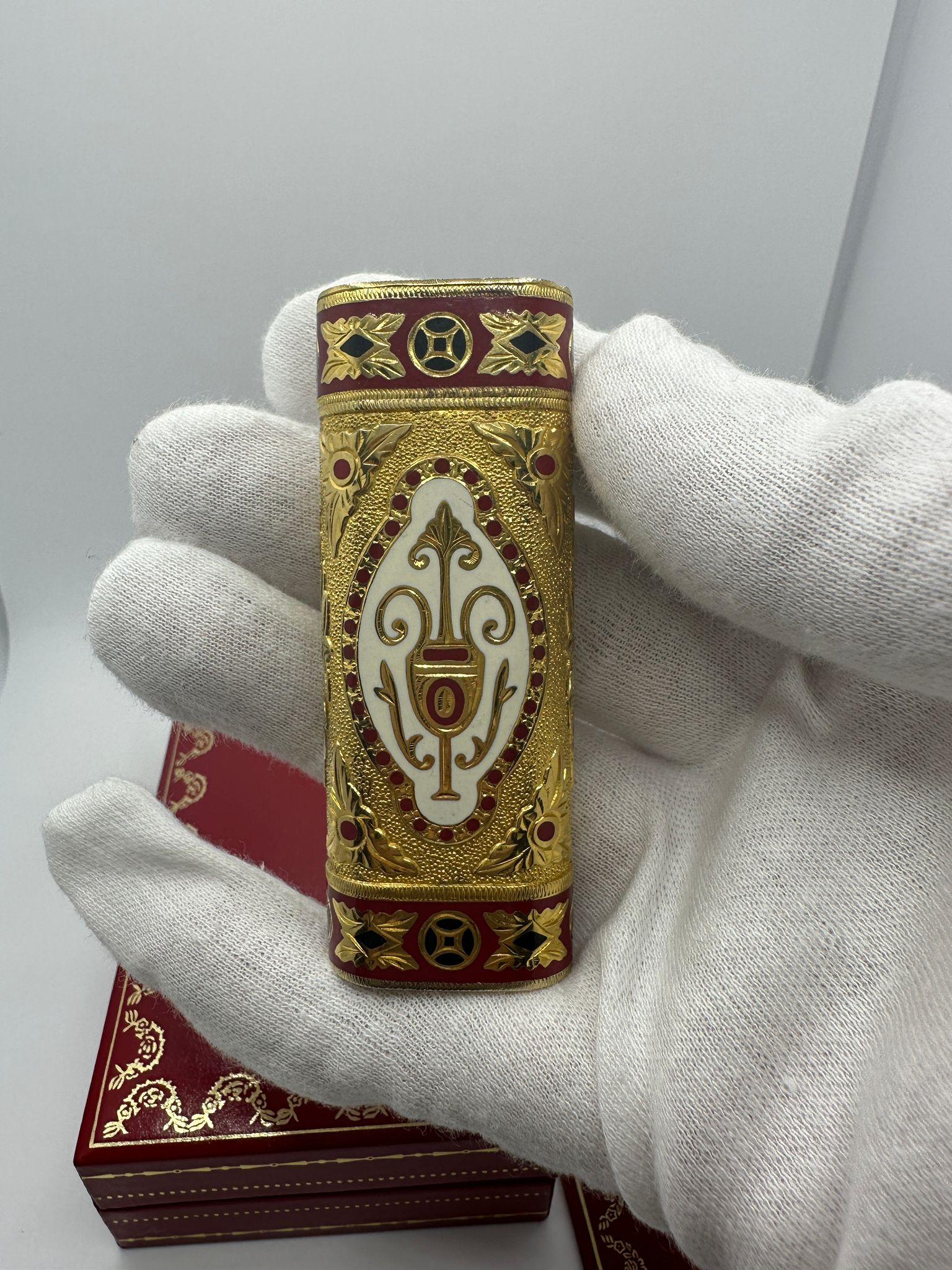 A rare Roy King 18k and enamel cigarette lighter, the rounded oblong body with hinged foliage-engraved lid and 'target' body, marked beneath '18k' with signature, 2.75