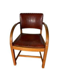 A vintage Art Deco-style armchair in the manner of Heals and Sons