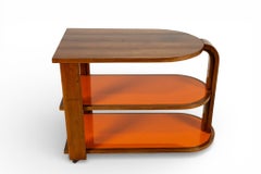 A Vintage Art Deco Style Bar Cart With Orange Glass Shelves