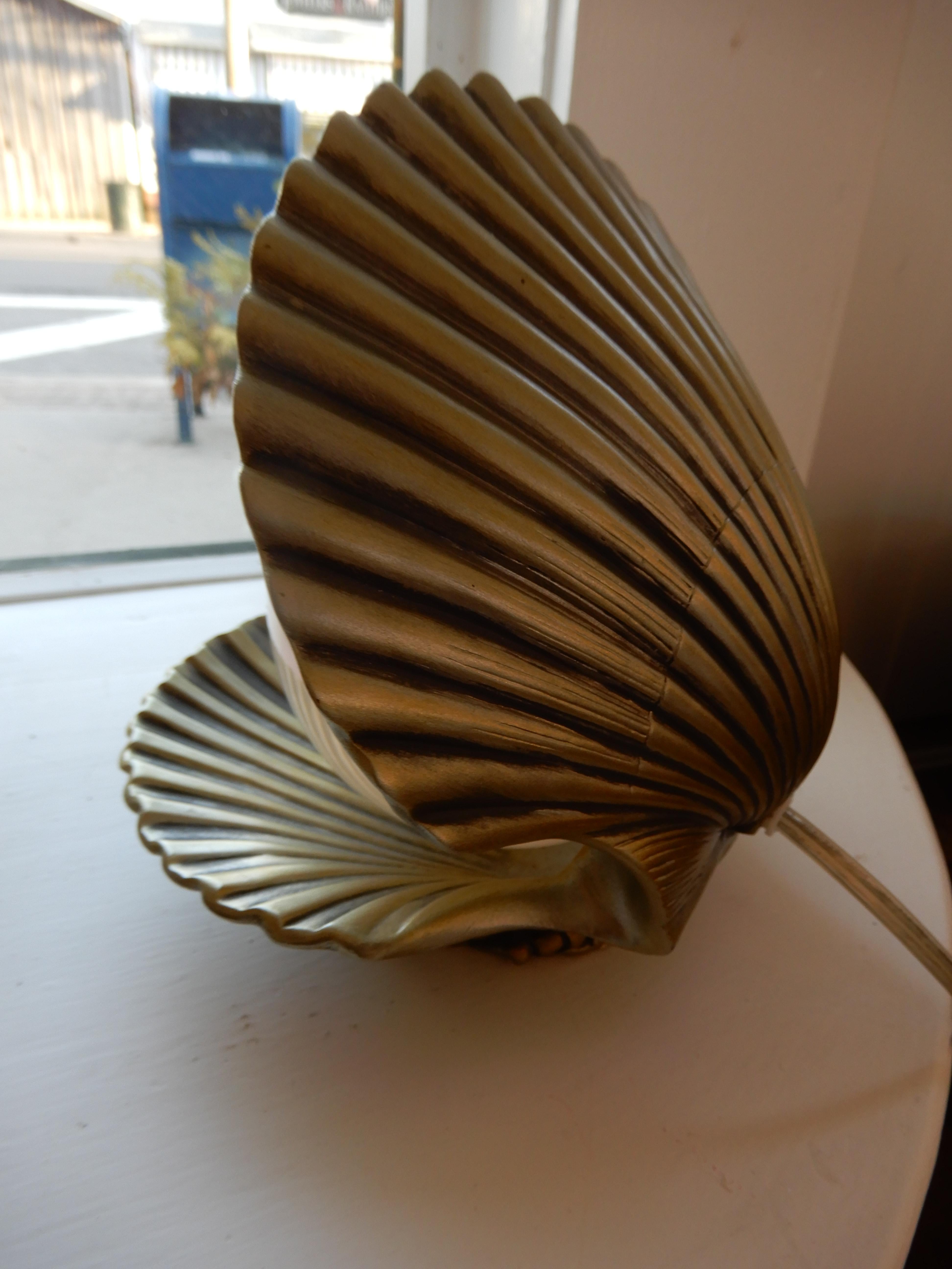In the Art Nouveau style a beautiful penalized glass shade nested in a well formed composition clam shell, a rare find. Good ambiance or night light use.