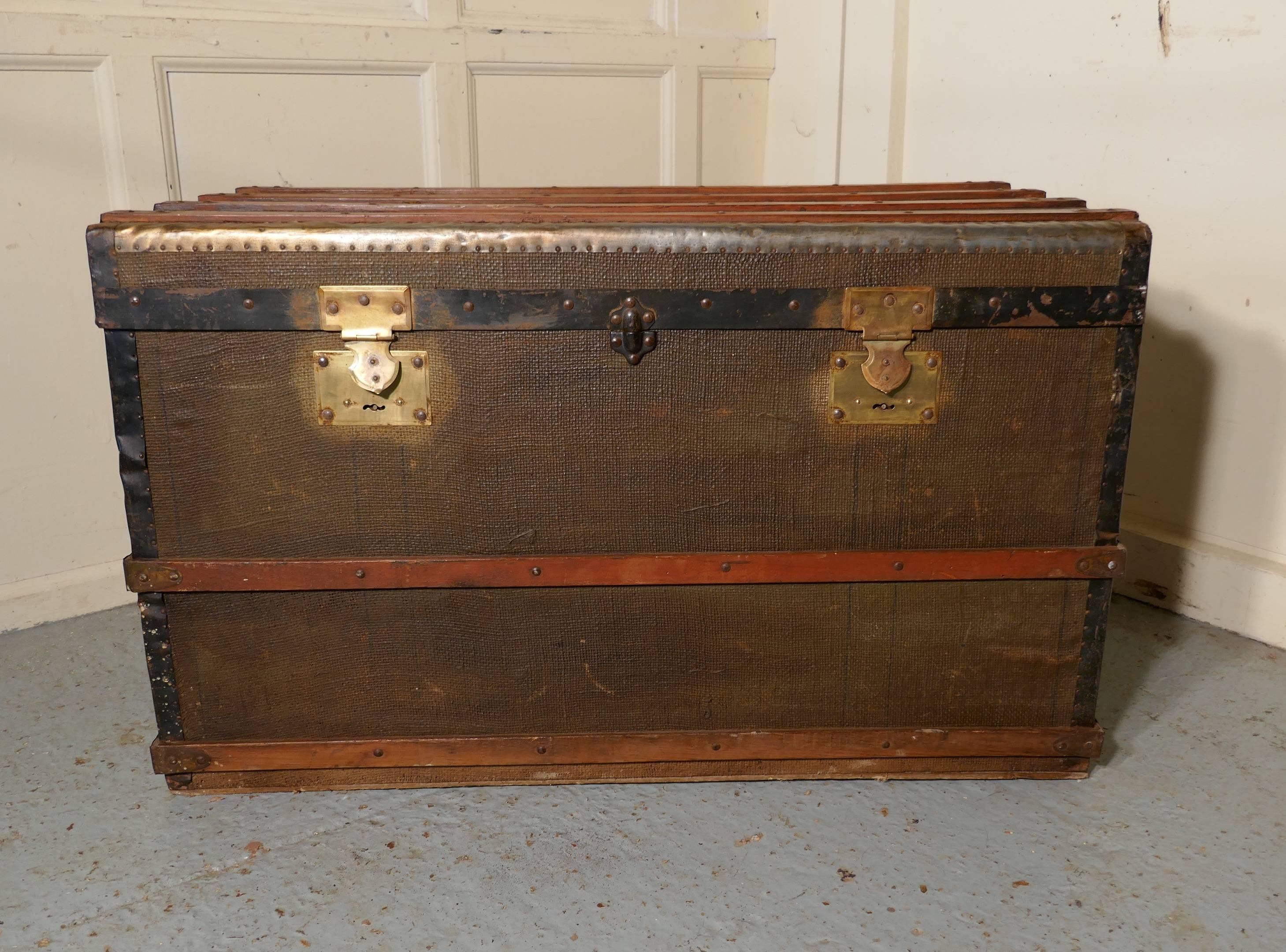 A vintage brass and bound canvas travel steamer trunk

A very useful decorative suitcase or travel trunk, it is lined in checked paper fabric, it has a fitted section inside with two removable trays at the top
The Trunk is canvas covered, it has