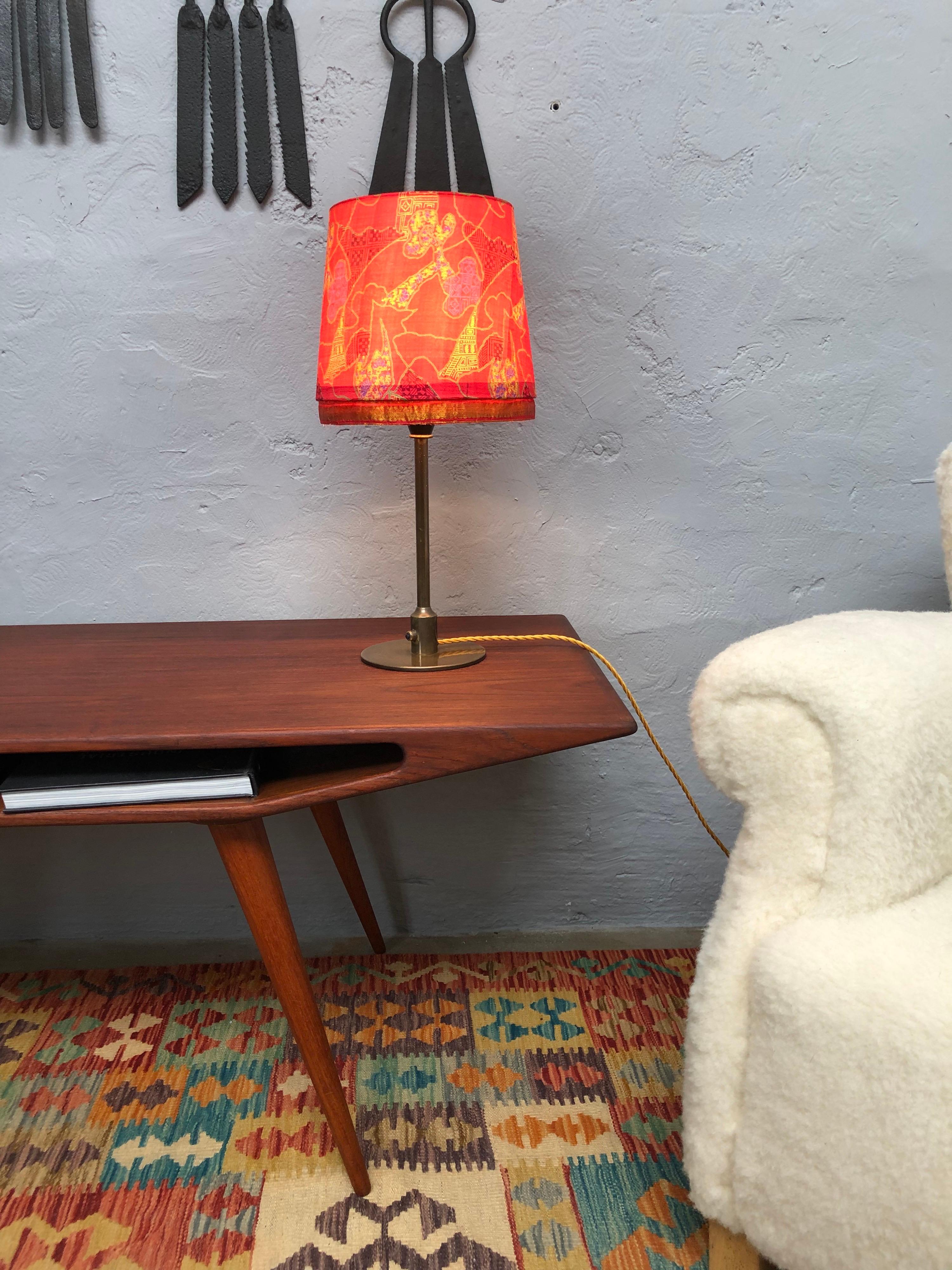 A vintage brass table lamp by Danish lighting company Fog & Mørup from the 1940s in the style of Poul Henningsen. 
The lamp has been dissembled and rewired with a twisted gold cloth flex and grounded. 
This Fog & Mørup table lamp has also been
