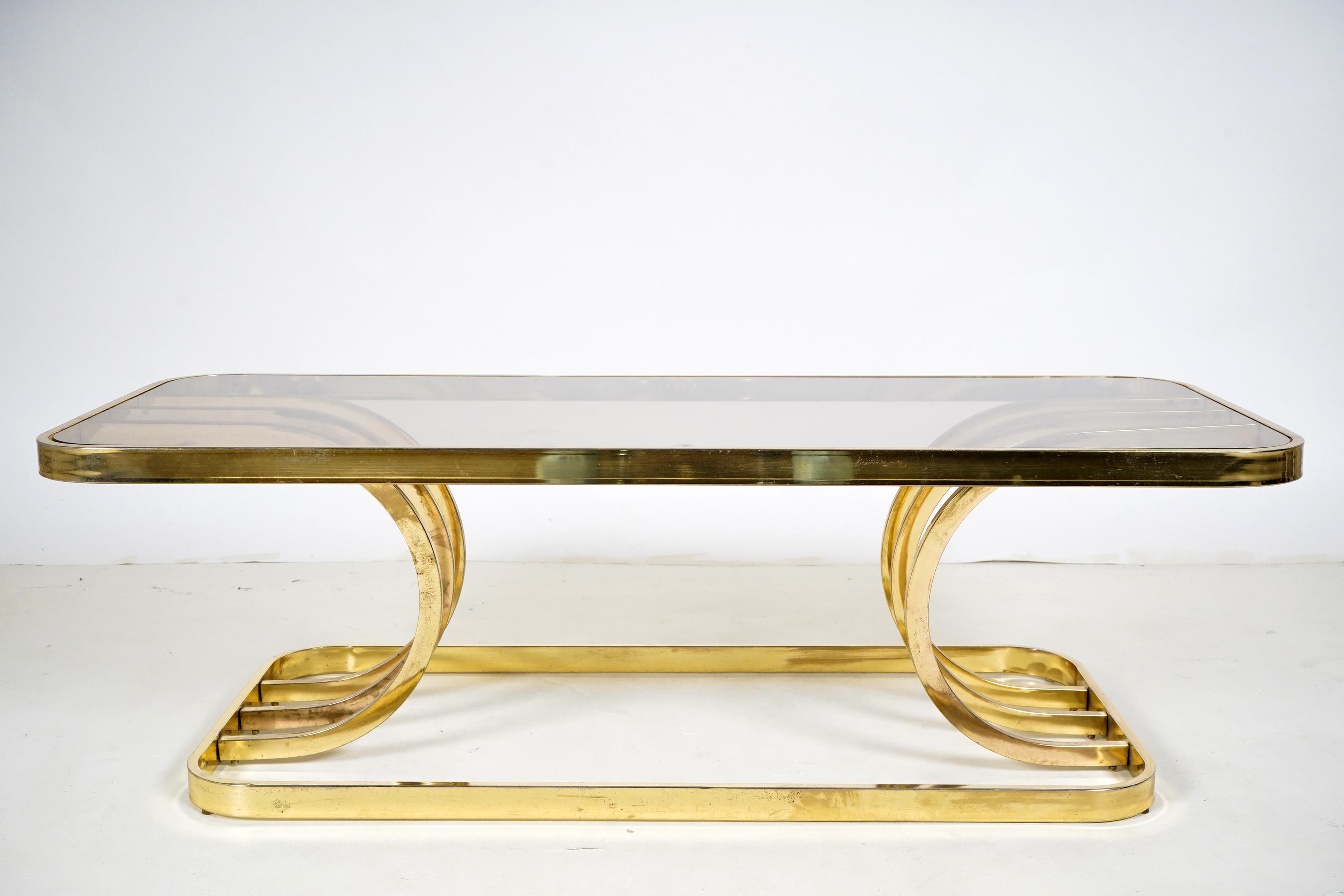 A brass-plated glass coffee table from the 1970s. During the interwar years Budapest was a hotspot of Art Deco furniture design and manufacturing. The Hungarian style was somewhat simpler than the French, combining traditional materials and