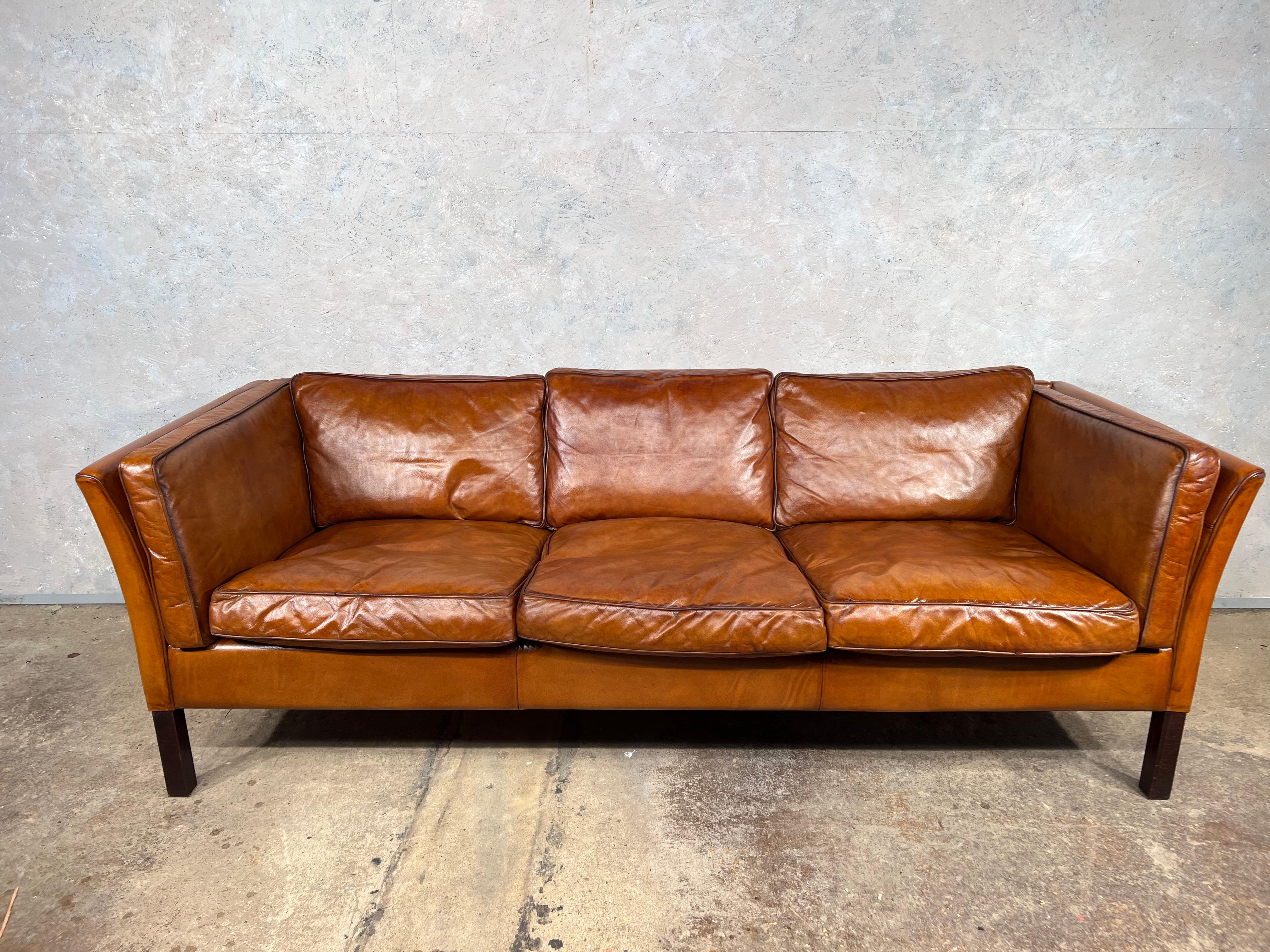 A Stunning Vintage Danish 70s Mid Century Tan Three Seater Leather Sofa.

Very stylish with a beautiful shape, great design, in great vintage condition, restored and hand dyed a beautiful tan colour and finish with great patina.

Viewings welcome at