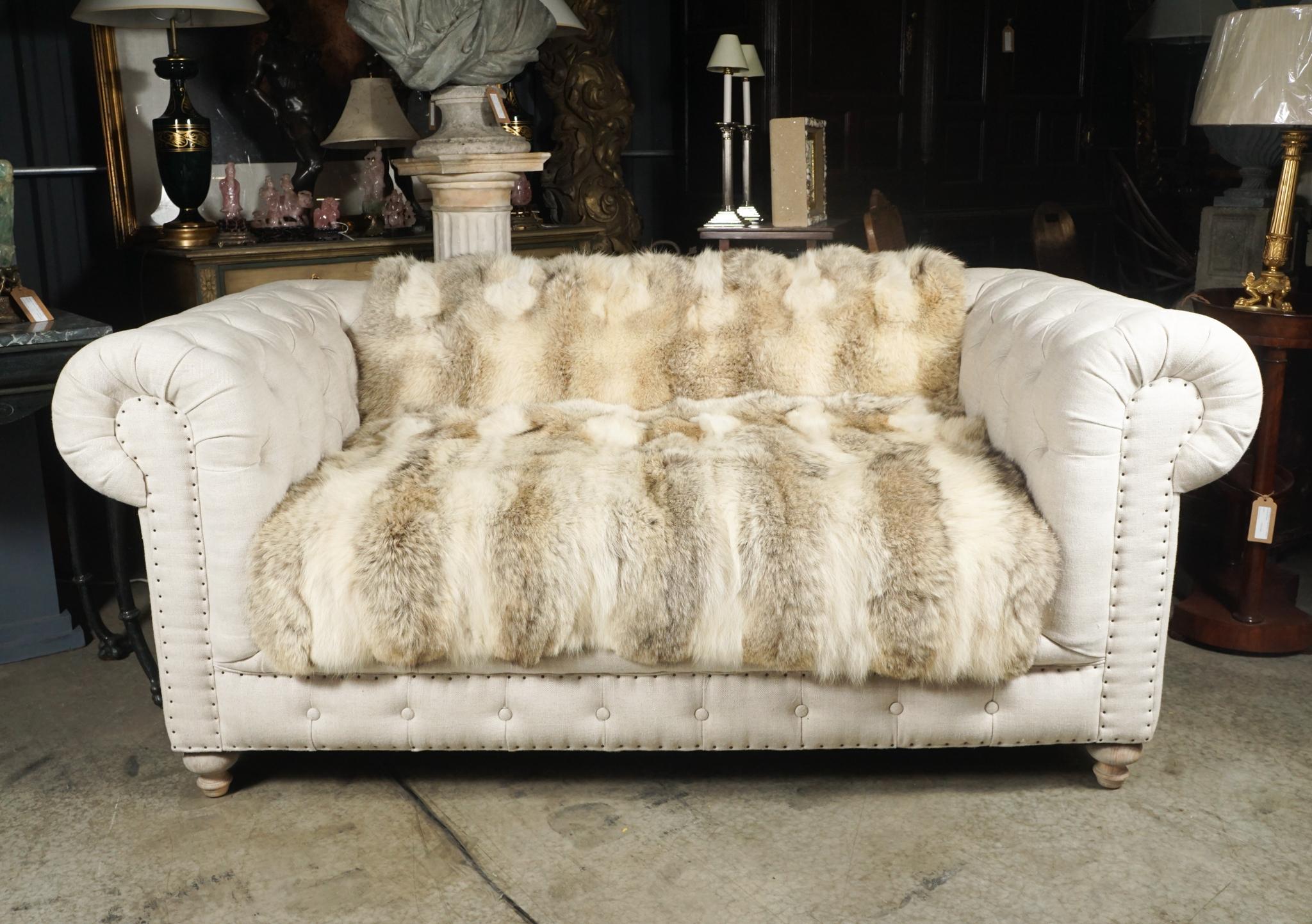 This vintage Edwardian style button tufted chesterfield has been gently used and shows no sign of abuse and very little use. Fashioned as if it came from an English interior circa 1900 but updated to a more casual and modern aspect with the cream
