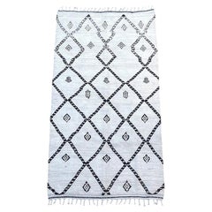 A vintage handwoven Moroccan berber rug with tribal diamond and line pattern