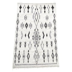 A vintage handwoven Moroccan berber rug, with tribal pattern