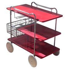 A vintage Italian modernist bar cart in cherry red, circa 1960
