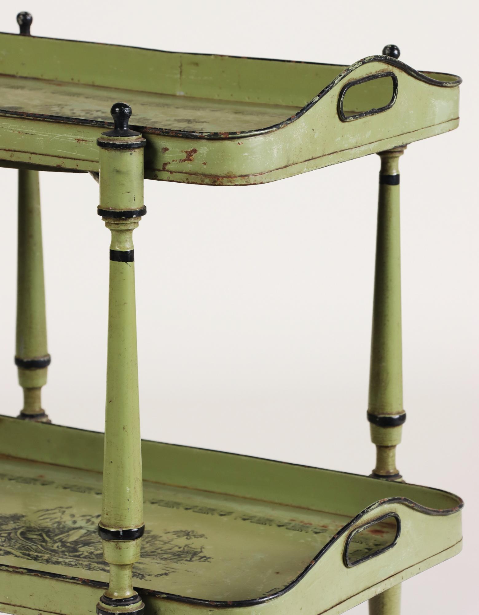 This exquisite Italian serving table from the 1940s features a two-tier design, offering both functionality and vintage charm. The table is constructed with a sturdy turned frame, supporting two removable tole trays. Each tray is adorned with