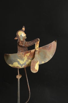 A vintage kinetic balance object of a small rowboat/Vintage iron balance toy