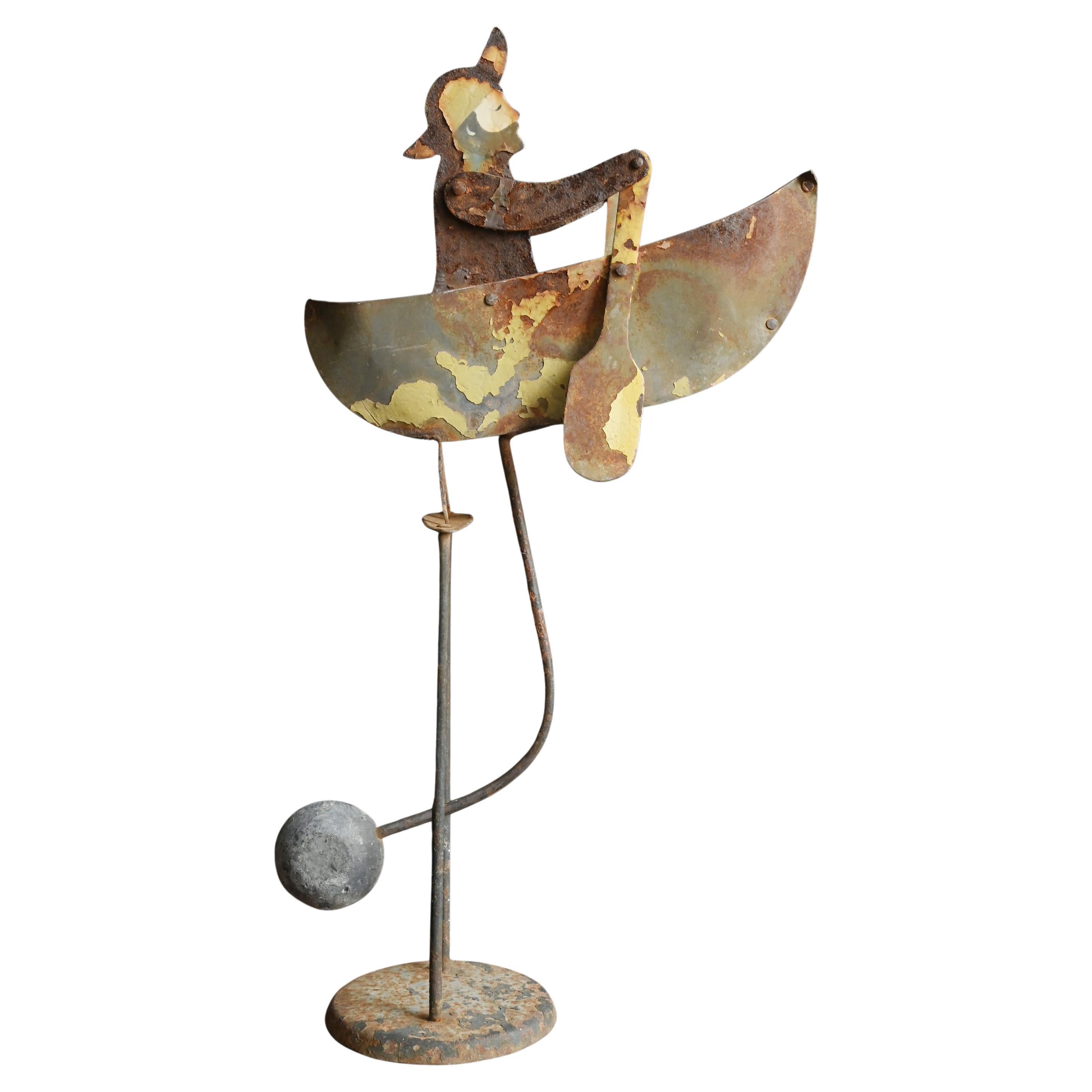 A vintage kinetic balance object of a small rowboat/Vintage iron balance toy For Sale