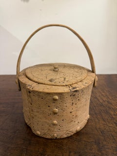 Un cesto di sughero con coperchio vintage e manico in legno